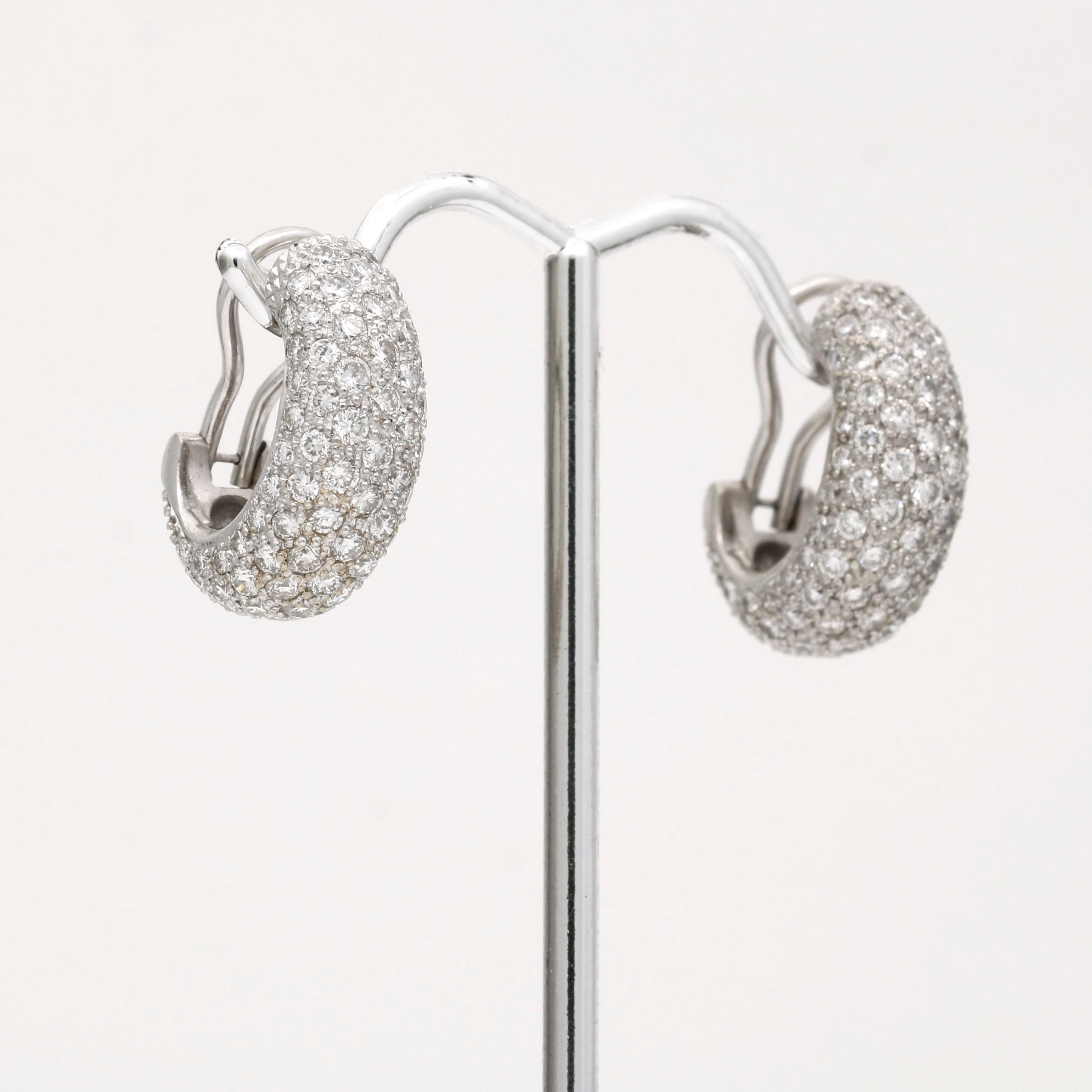 These earrings feature a beautiful and classic design with a C-shaped hoop encrusted in sparkling pave diamonds. The diamonds are of high quality, weighing a total of 3.80 carats, have a near-colorless appearance, and are very clean, with only minor