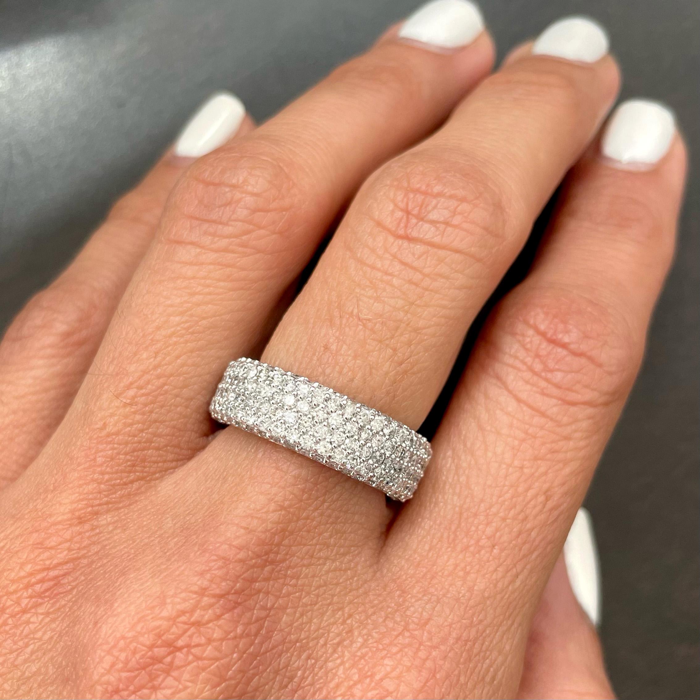 This beautiful diamond eternity band features pave set diamonds in a polished finish. The ring is made of 14k white gold and set with 3.59 carats (total weight) of brilliant round-cut diamonds, which are G/H color and SI2 clarity. The ring is new
