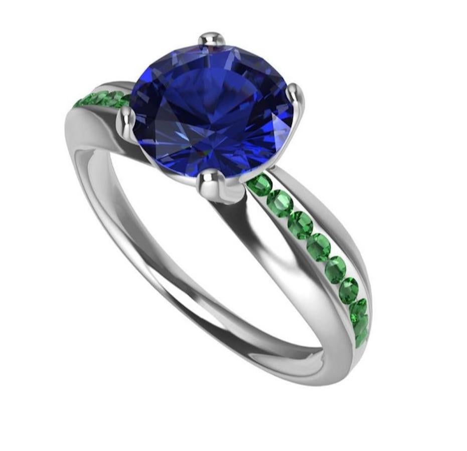 Platinum Sapphire and Tsavorites Cocktail Ring, Tiffany designer , Thomas Kurilla is going back to his sculpture days. This freeform ring evokes the passion of quick decisions, soft shapes, and simple elegant curves. A 1.55 Carat  blue sapphire with