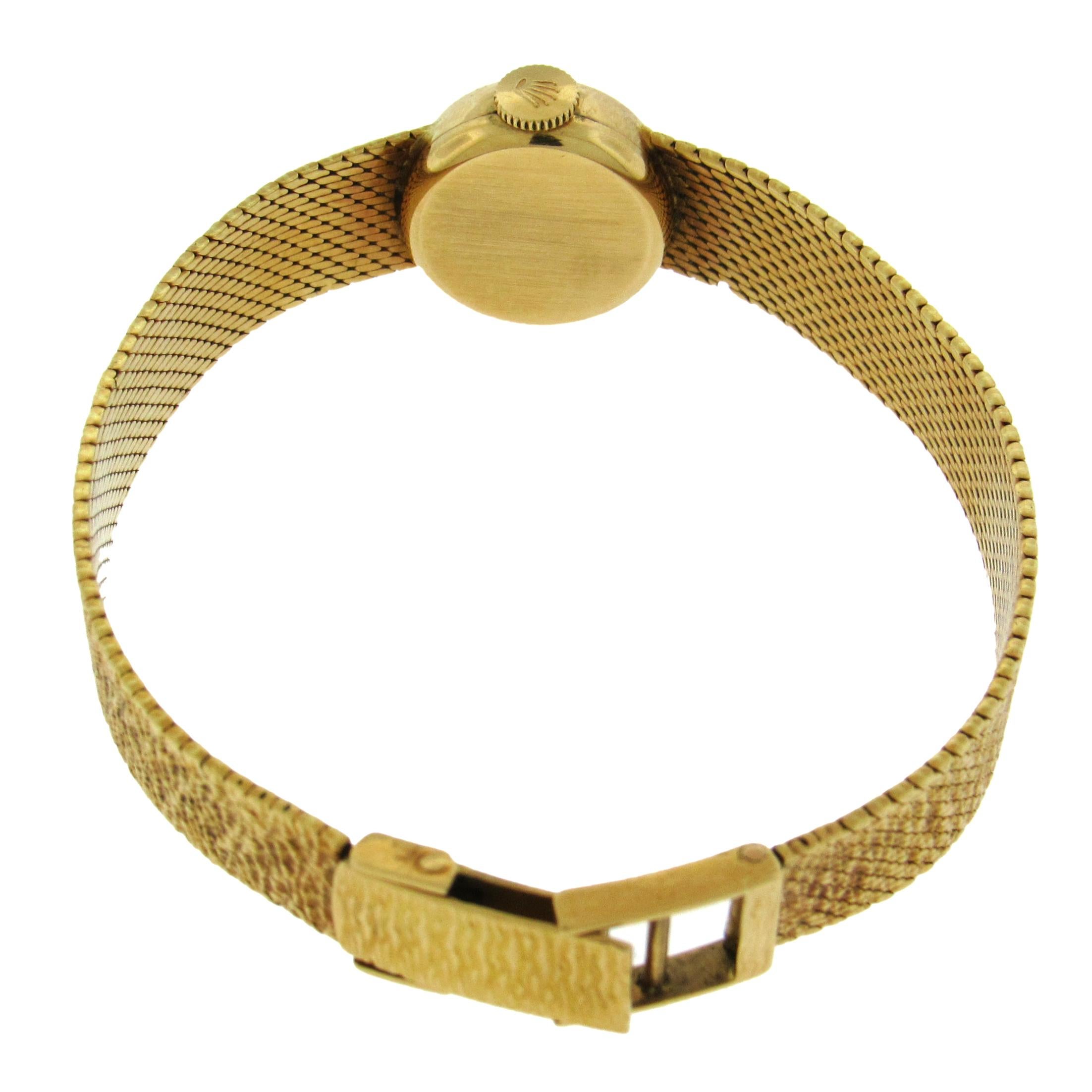 18K yellow gold women’s Rolex Precision, Ref. J360, circa 1950, is a 15mm manual wind cocktail watch, silver dial with applied yellow gold hour indexes, tapered integrated mesh bracelet, overall length 6-1/2″, 18 jewel caliber 1401 manual wind
