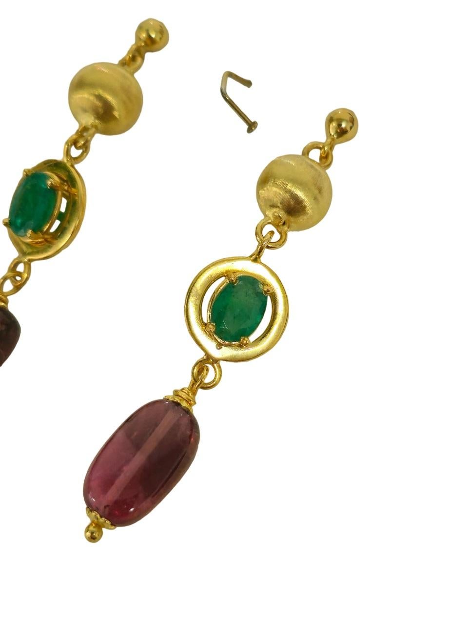 Indulge in timeless elegance with these stunning dangle earrings, crafted from solid 14K yellow gold. Gracing each earring are enchanting emeralds, boasting a total carat weight of 1.50 carats. These gems, set delicately in prongs, showcase the