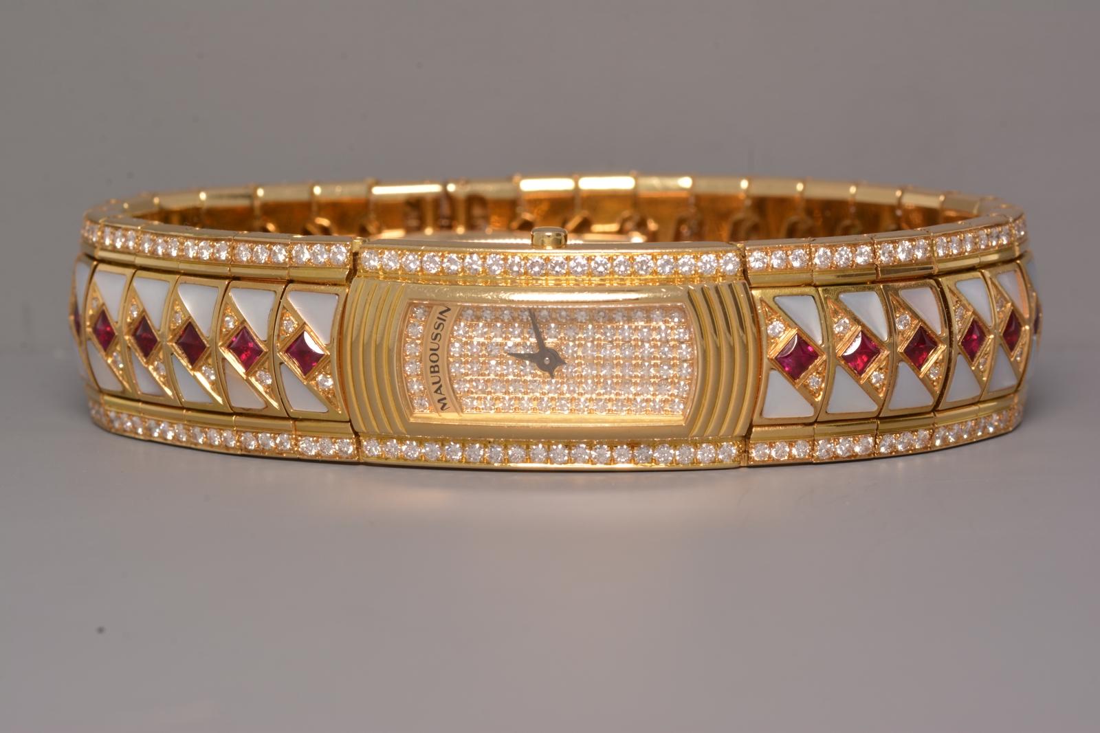 Women's Lady M Maxi Mauboussin, Diamond, Ruby, Mother of Pearl 18K Yellow Gold Watch
 
Brand:
Mauboussin
Model:
R.68800 Lady M Maxi No.122G
Produced in France in the 1990's.
Diamonds:
4.65 carat   Color:  F-G   Clarity:  VVS1-VS2
Secondary