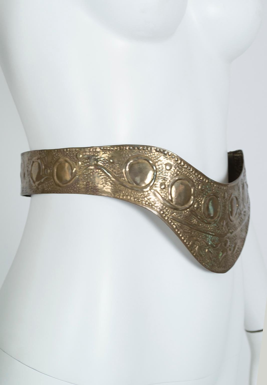 Feel invincible with this superhero-worthy statement belt. Equal parts waist cincher and midriff cuirasse, the belt is light as air despite looking like a piece of medieval armor and demands attention every time it's worn. Unique, fierce and