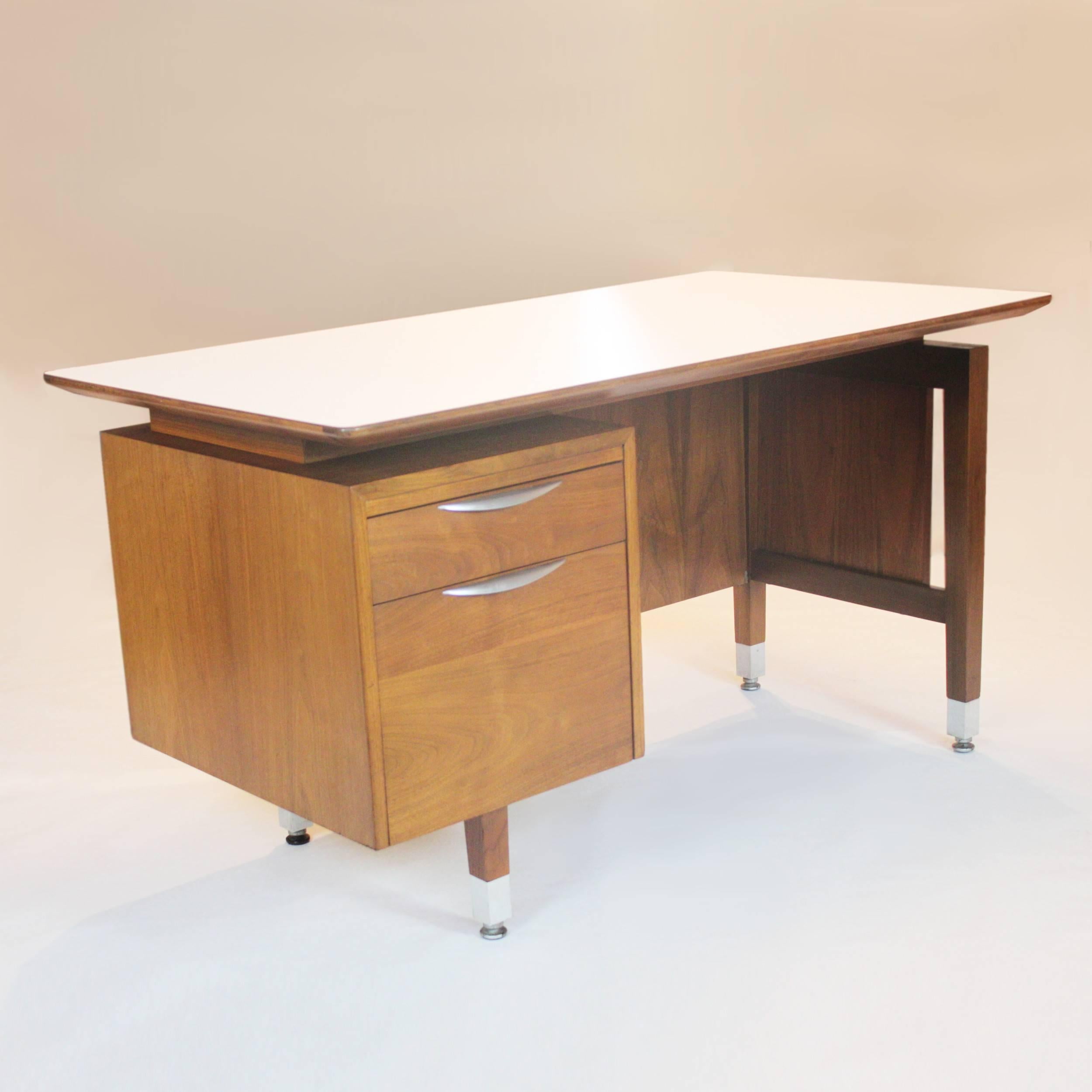 This wonderful Mid-Century Modern desk by Thonet of New york has the perfect amount of everything. The beautiful Jens Risom-Esqe design features a floating top with perfectly contrasting white formica and swoopy aluminum drawer pulls that tie in