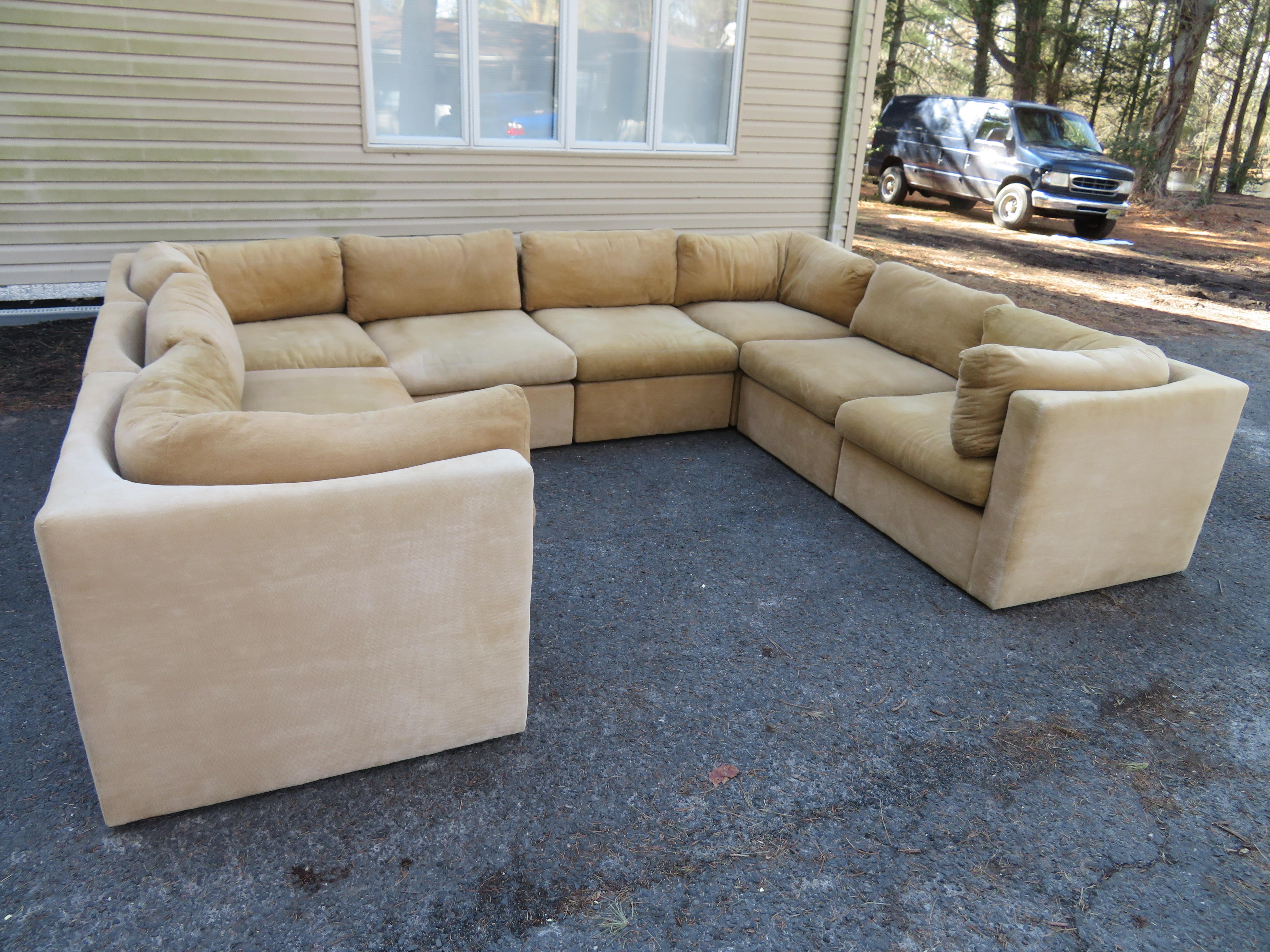 Wonderful signed Milo Baughman 8 piece sectional sofa with unusual curved seat backs. The original fabric on this sectional is presentable and could be used as is-some fading and wear. This sectional consists of 4 corners and 4 armless sections.