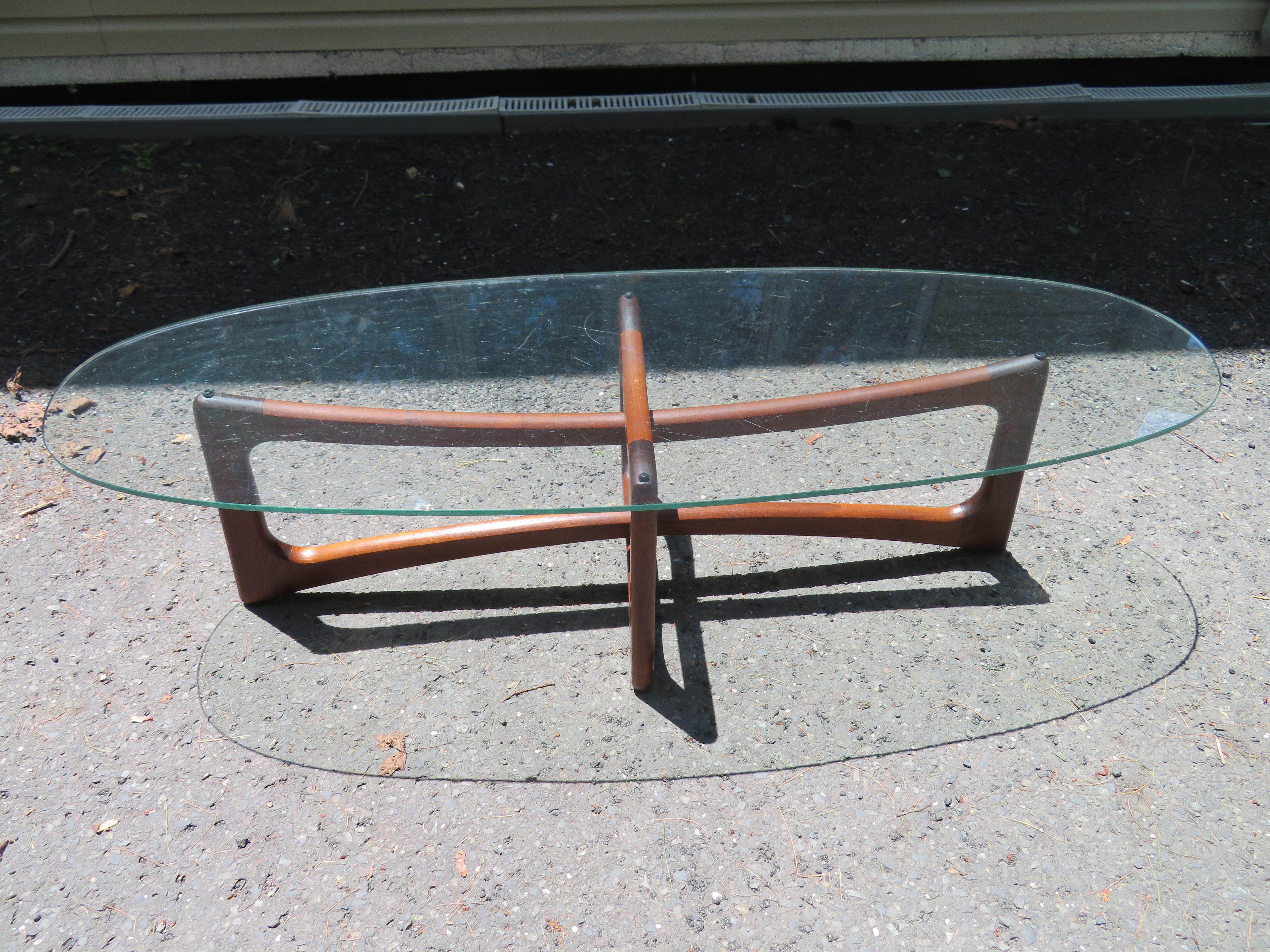 Wonderful Adrian Pearsall sculptural walnut dog bone coffee table. The walnut base retains its original rubbed oil finish and still looks great-new rubber bumpers. The original glass has some chips so we will have a new piece cut.