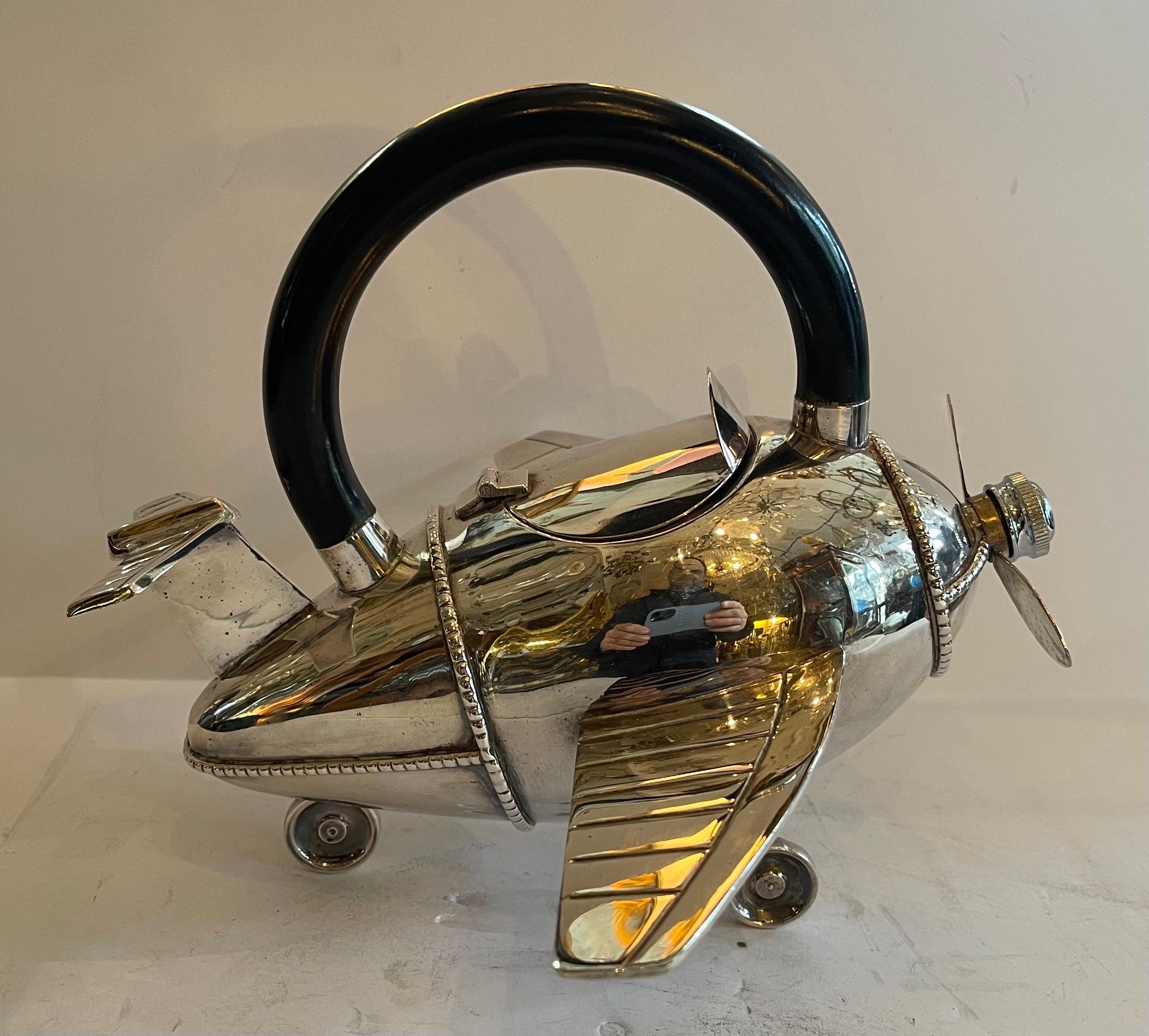 Wonderful airplane form modern polished silver plate martini / cocktail bar shaker with black lacquered wood handle, a beautiful display piece appears to never have been used
In the manner of J.A. Henckels.