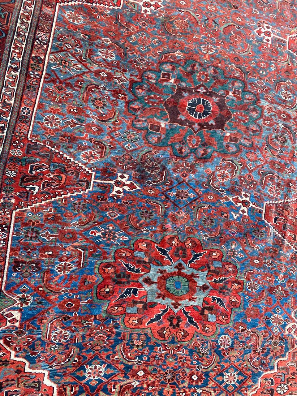 Discover the timeless elegance of a late 19th-century fine Afshar rug. Hand-knotted with meticulous craftsmanship, this masterpiece features a decorative design on a deep navy background. Stylized floral motifs in red, brown, green, orange, and