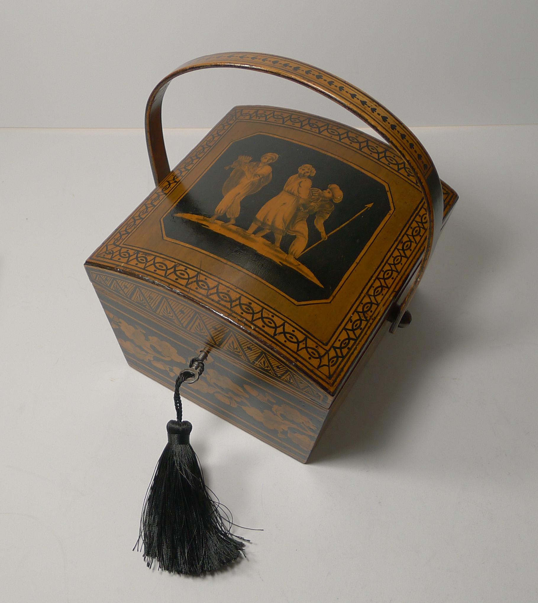 An absolutely charming Regency sewing box in the form of a basket with it's original bentwood folding swing handle.

The domed top features a figural scene with one of the men holding a Crown. The sides are decorated with a very English Oak Leaf