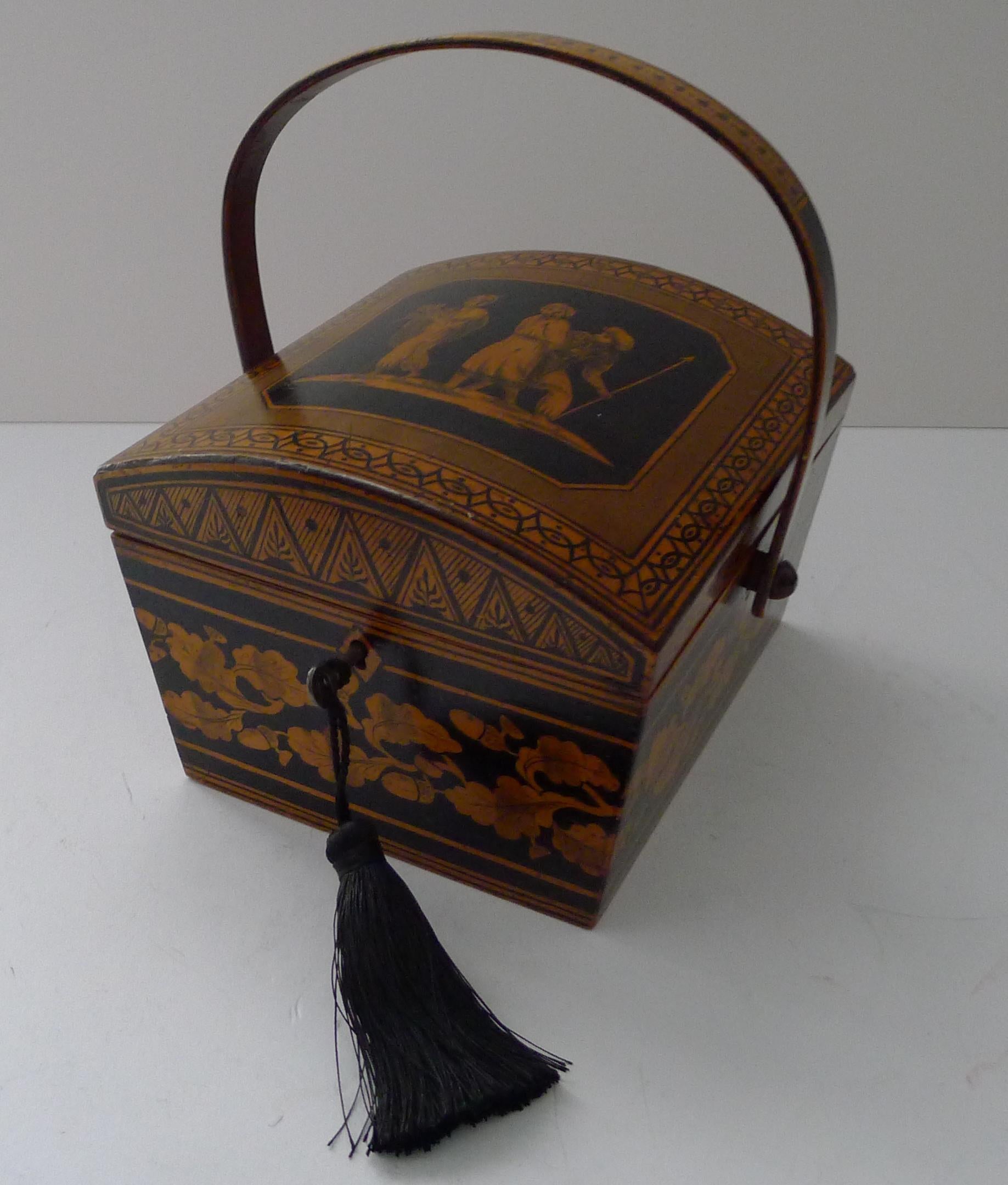 An absolutely charming Regency sewing box in the form of a basket with it's original bentwood folding swing handle.

The domed top features a figural scene with one of the men holding a Crown. The sides are decorated with a very English Oak Leaf and