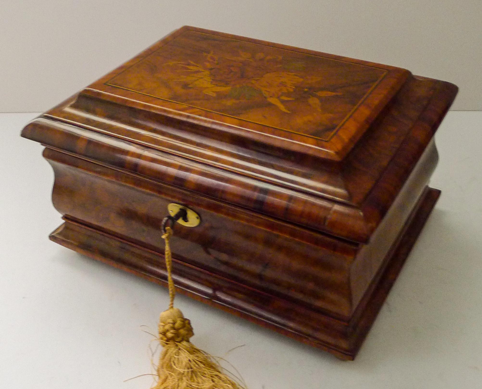 A fabulous and most unusual tea caddy dating to the Regency era, around 1820.

A rare combination of woods has been used, nutty Cognac coloured Walnut and rich graphic Tulipwood.

The top has exquisite and intricate Marquetry inlay featuring a