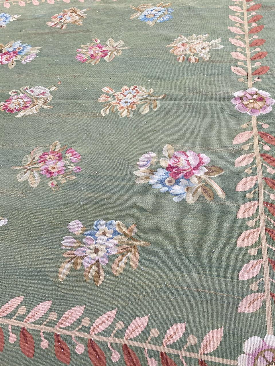 Very beautiful late 19th century French Aubusson rug with beautiful floral Empire style design (First French Empire of the early 19th century), and beautiful green background color, characteristic of this style, with pink and blue, entirely hand