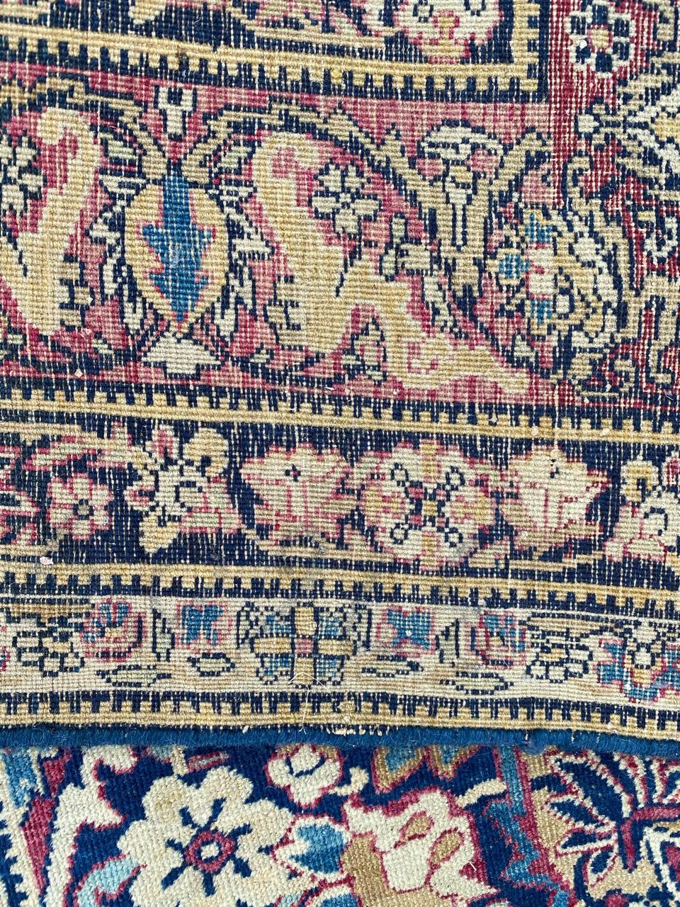 Very beautiful late 19th century rug with a nice floral and central medallion design and beautiful natural colors with dark blue, yellow, blue and red, entirely and finely hand knotted with wool velvet on cotton foundation.