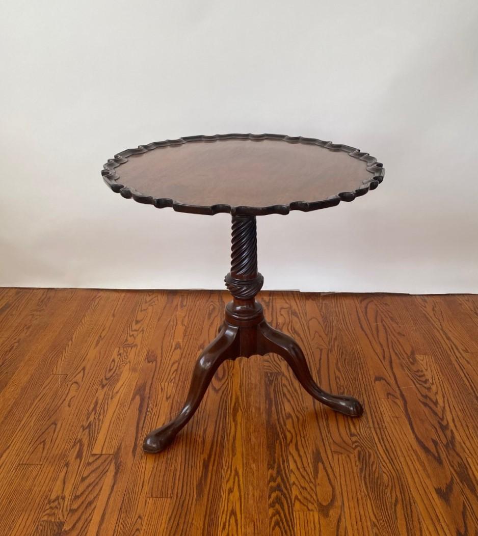 Antique Mahogany English made tilt top tripod table with piecrust shaped top, spiral carved column and cabriole legs with pad feet. Nice patina. Made the proper way. Circa 1800.