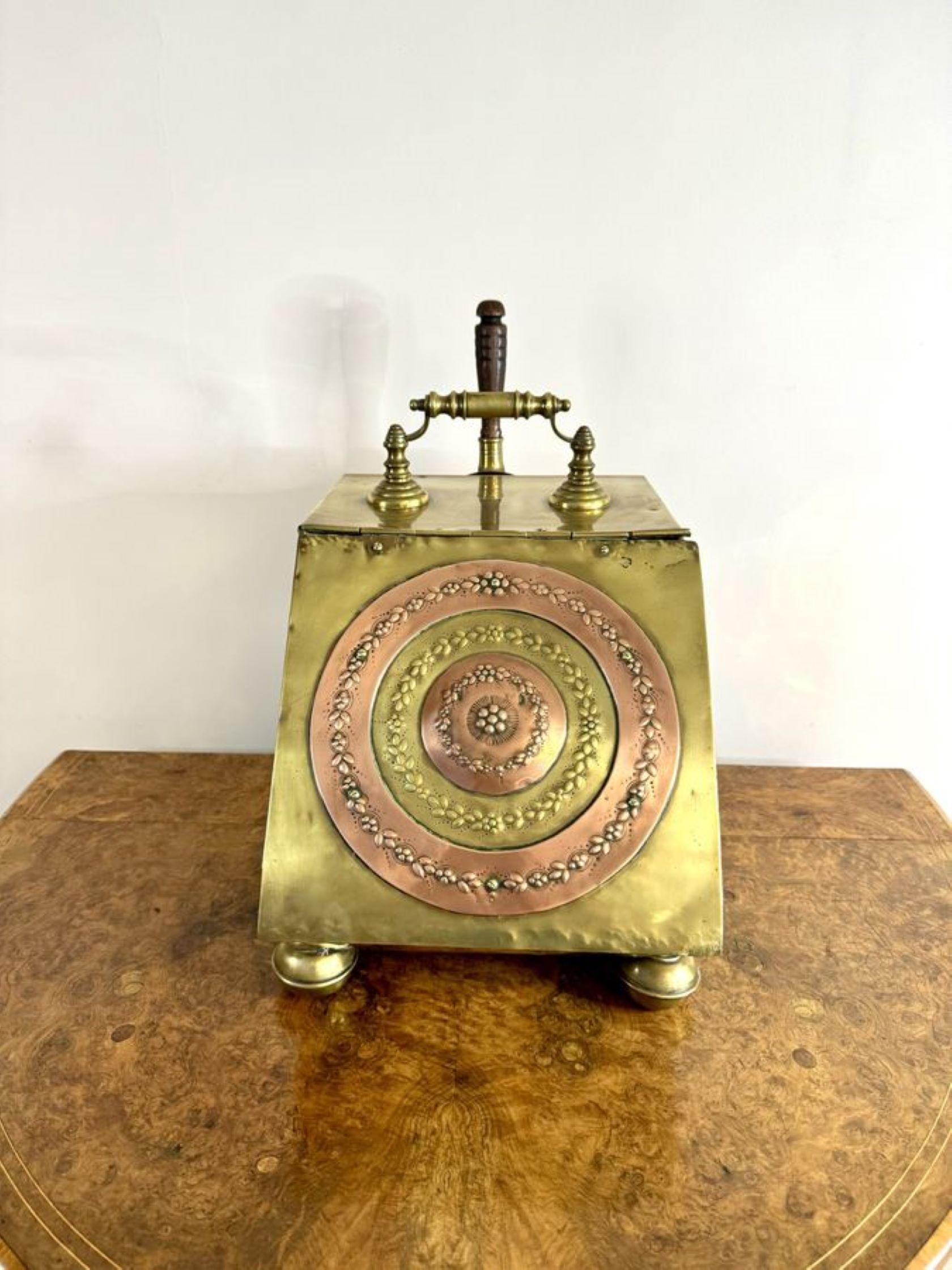 Wonderful antique Victorian brass and copper coal box, having a quality brass coal box with copper inset decoration to the front, with a lift up lid opening to reveal a compartment for coal, raised on turned brass feet, with the original wooden