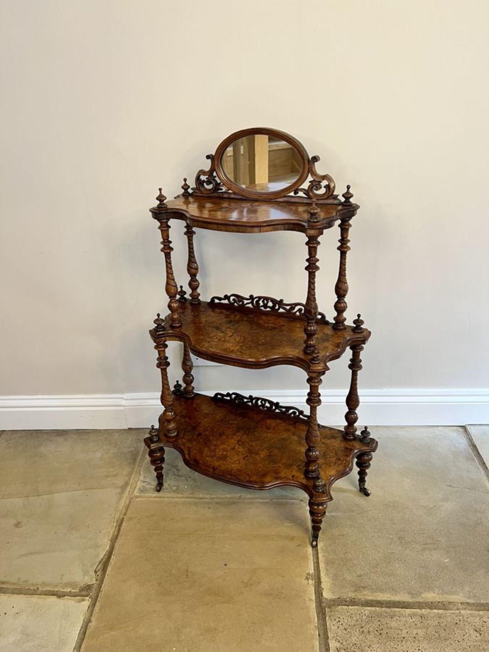 Wonderful antique Victorian quality burr walnut whatnot, having an oval mirror with carved walnut supports to the top above three quality burr walnut serpentine shaped display shelves, supported by turned tapering columns, standing on turned legs