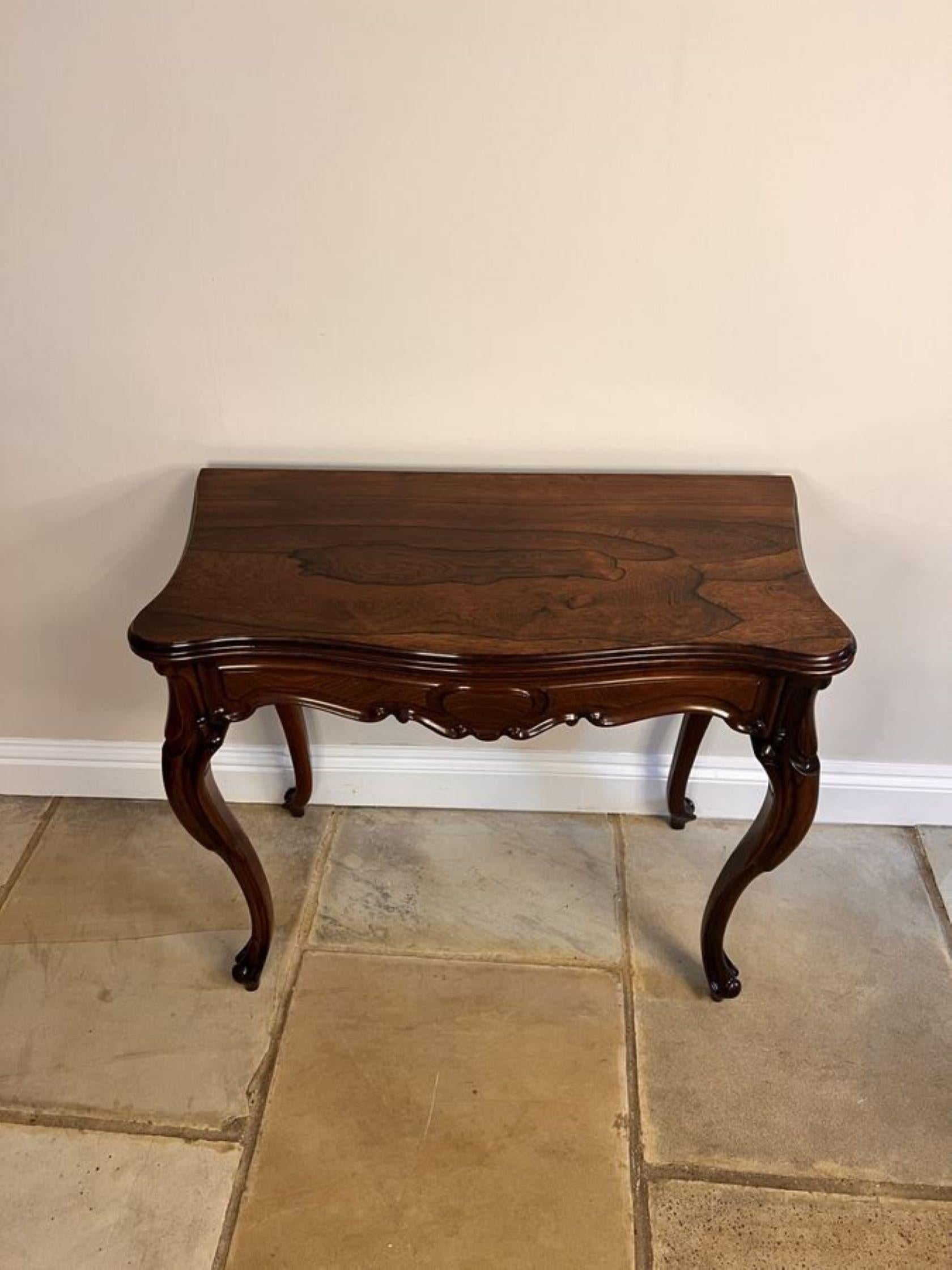 Wonderful antique Victorian quality rosewood tea table, having a quality rosewood serpentine shaped top with a moulded edge opening to reveal a superb polished interior, carved rosewood frieze standing on shaped carved cabriole legs with scroll