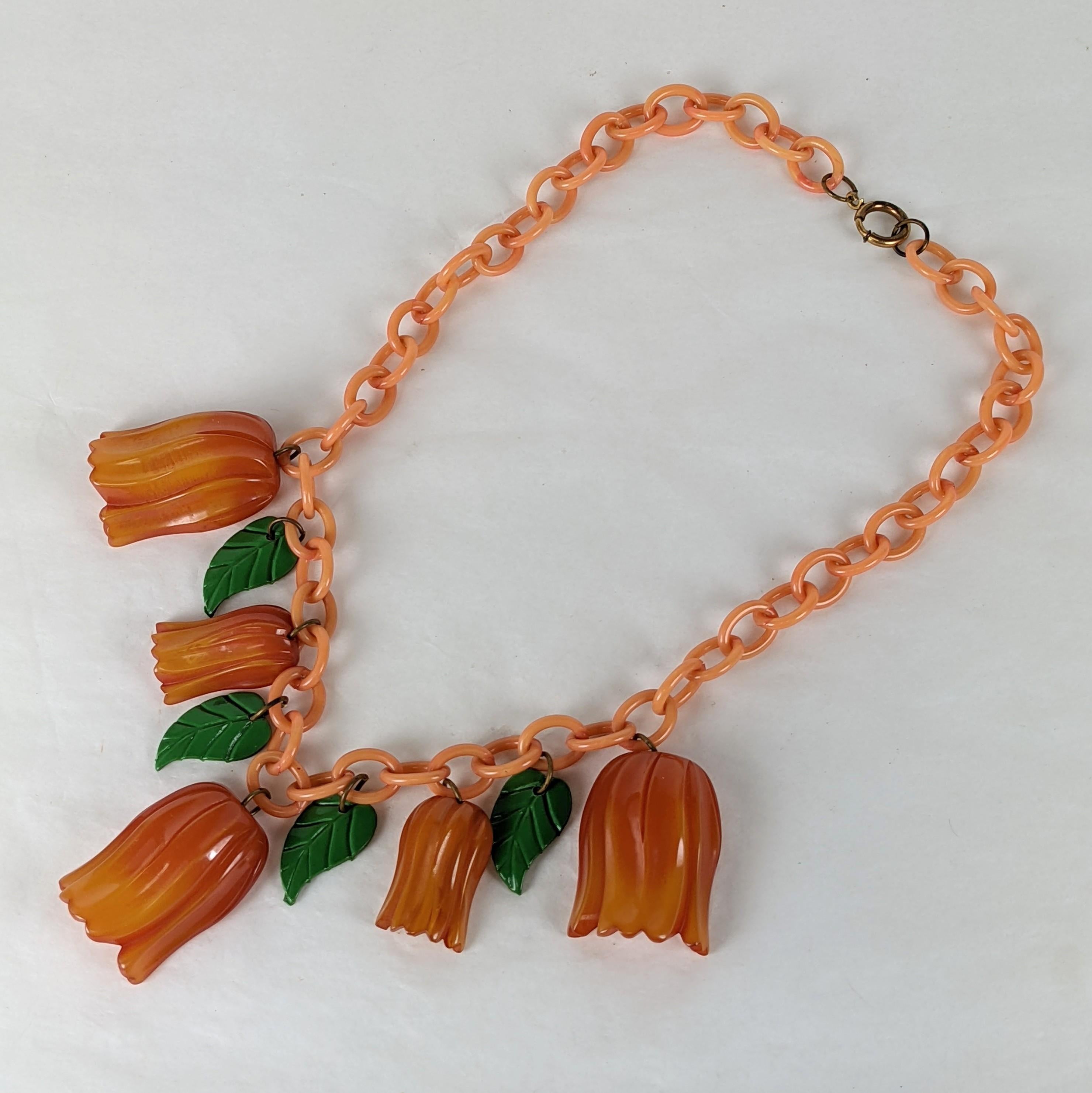 Wonderful and Rare Bakelite Tulip Necklace from the Art Deco period. Hand carved tulip heads of different sizes retain their original tonal patina and are suspended from the original celluloid chain with celluloid leaves. Unusual subject matter, a