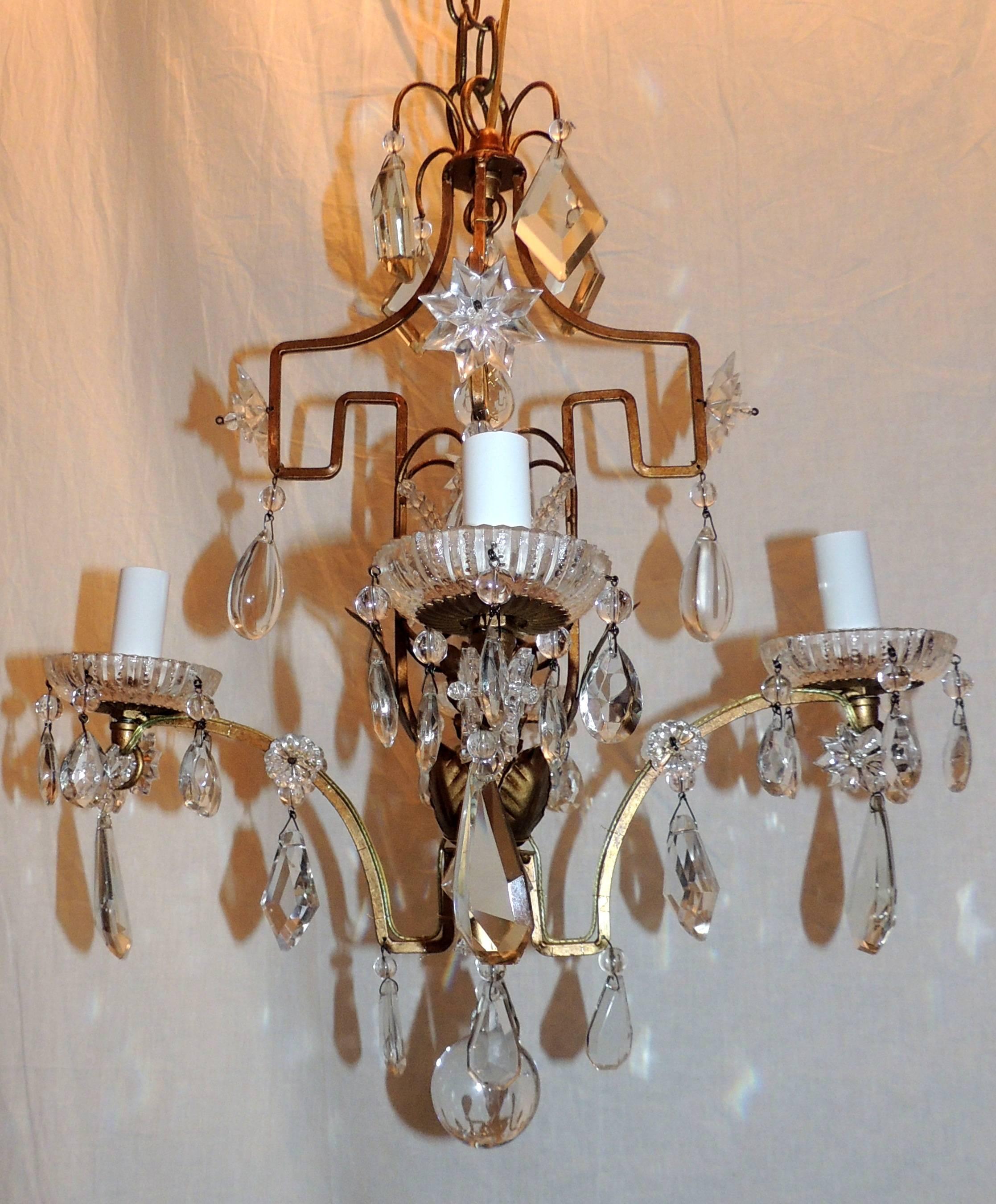 A wonderful Bagues French gilt crystal beaded petite chandelier four-light fixture with a beautiful crown and surrounded by crystal stars.
The perfect piece for a small space.