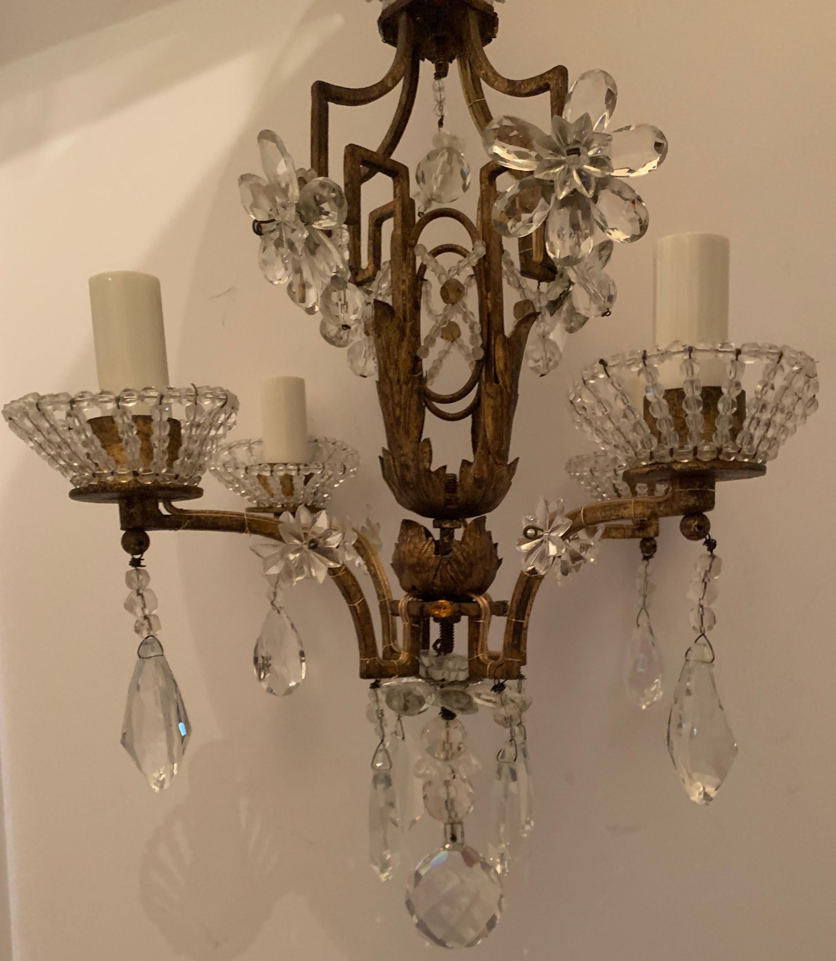 A wonderful Bagues style French gold gilt crystal beaded petite chandelier four-light fixture with a beautiful crown and surrounded by crystal stars.
The perfect piece for any small space.