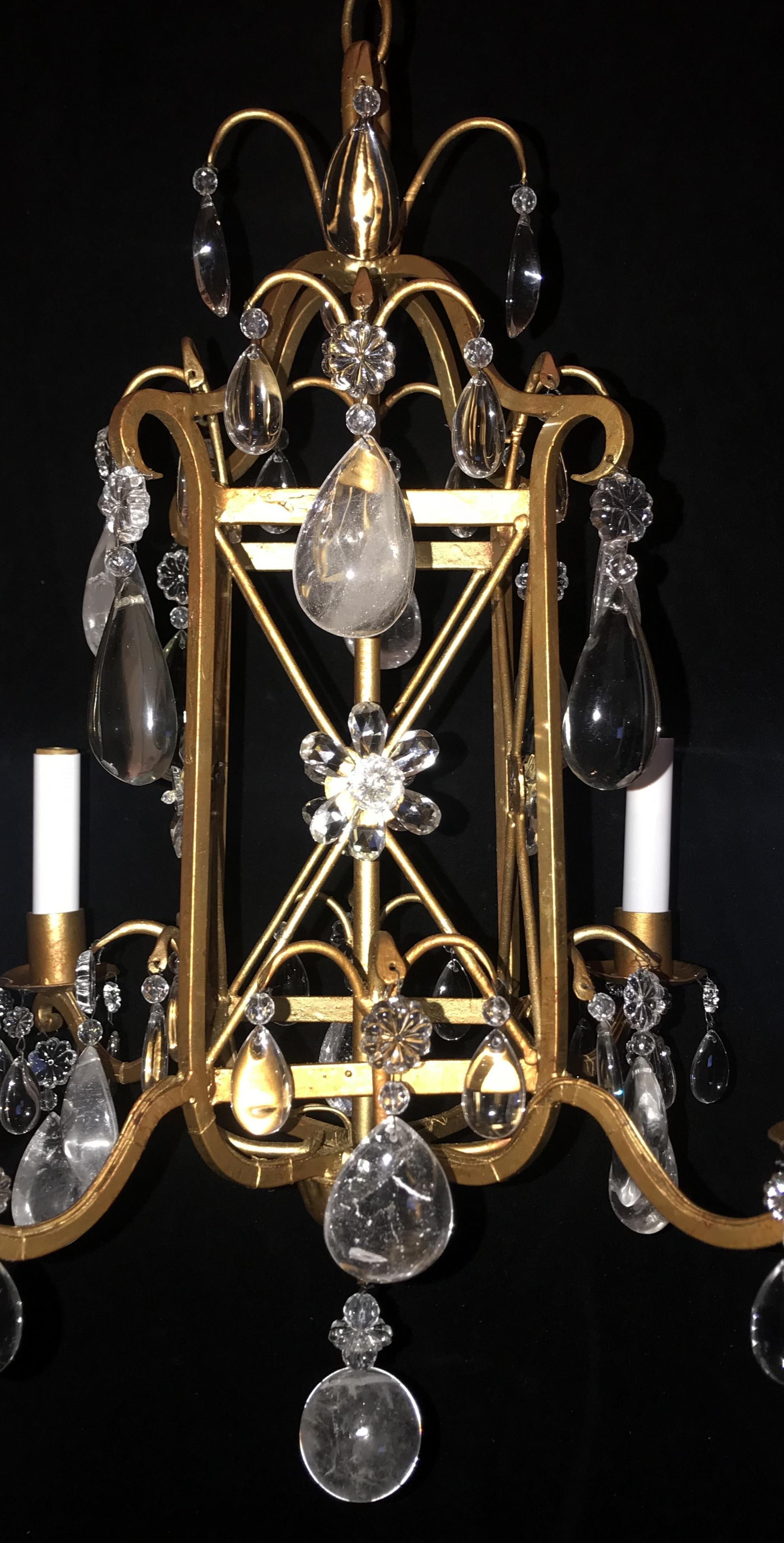 A wonderful Baguès French gold gilt rock crystal and beaded petite chandelier with four-lights and centered with a beautiful square frame and surrounded with crystal flowers and finished with a rock crystal ball on the bottom. This fixture has been