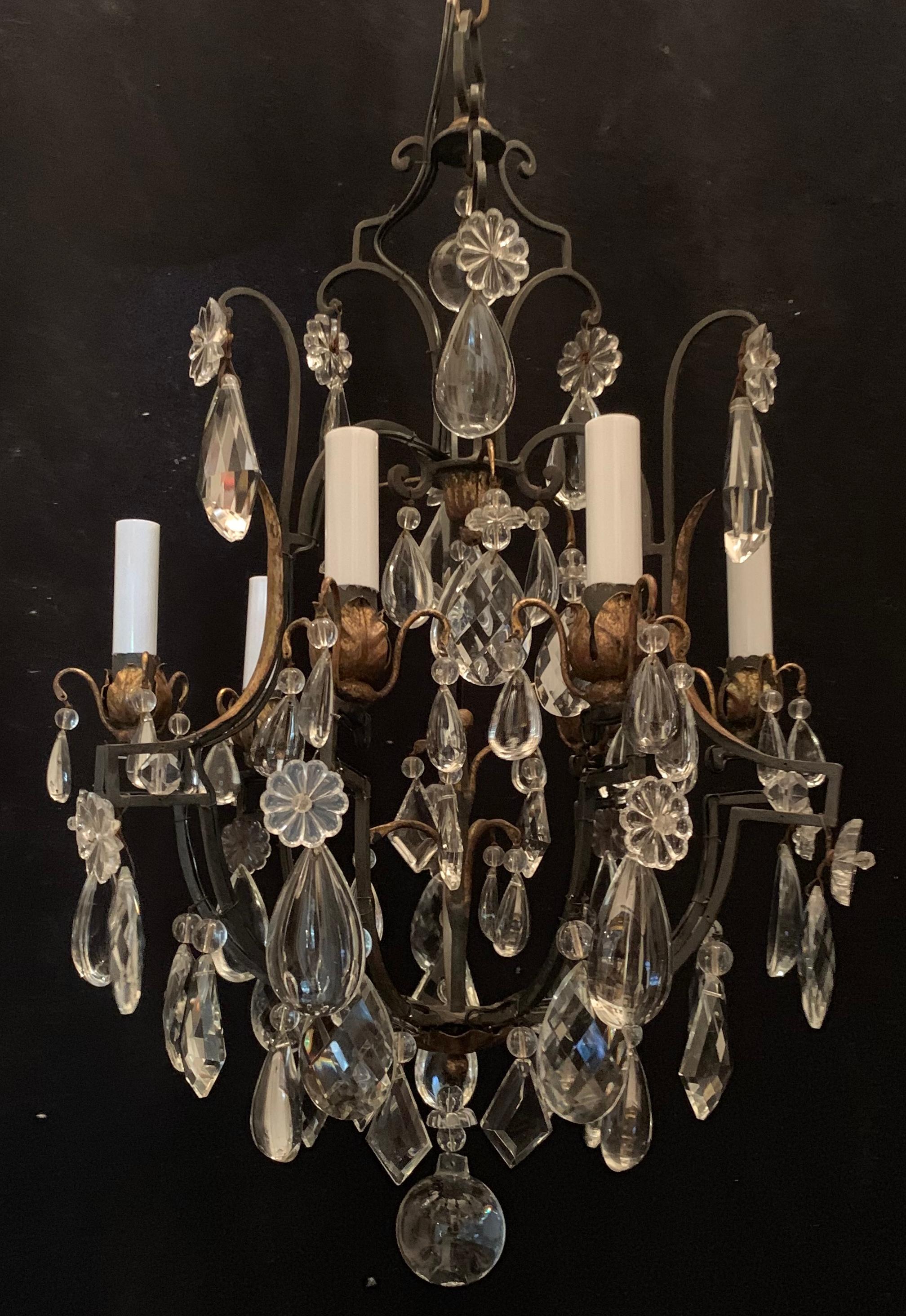A wonderful Baguès style French iron & gold gilt crystal filigree beaded flower bird cage form 6-candelabrum chandelier.
Completely rewired with new sockets and accompanied by chain canopy and mounting hardware.