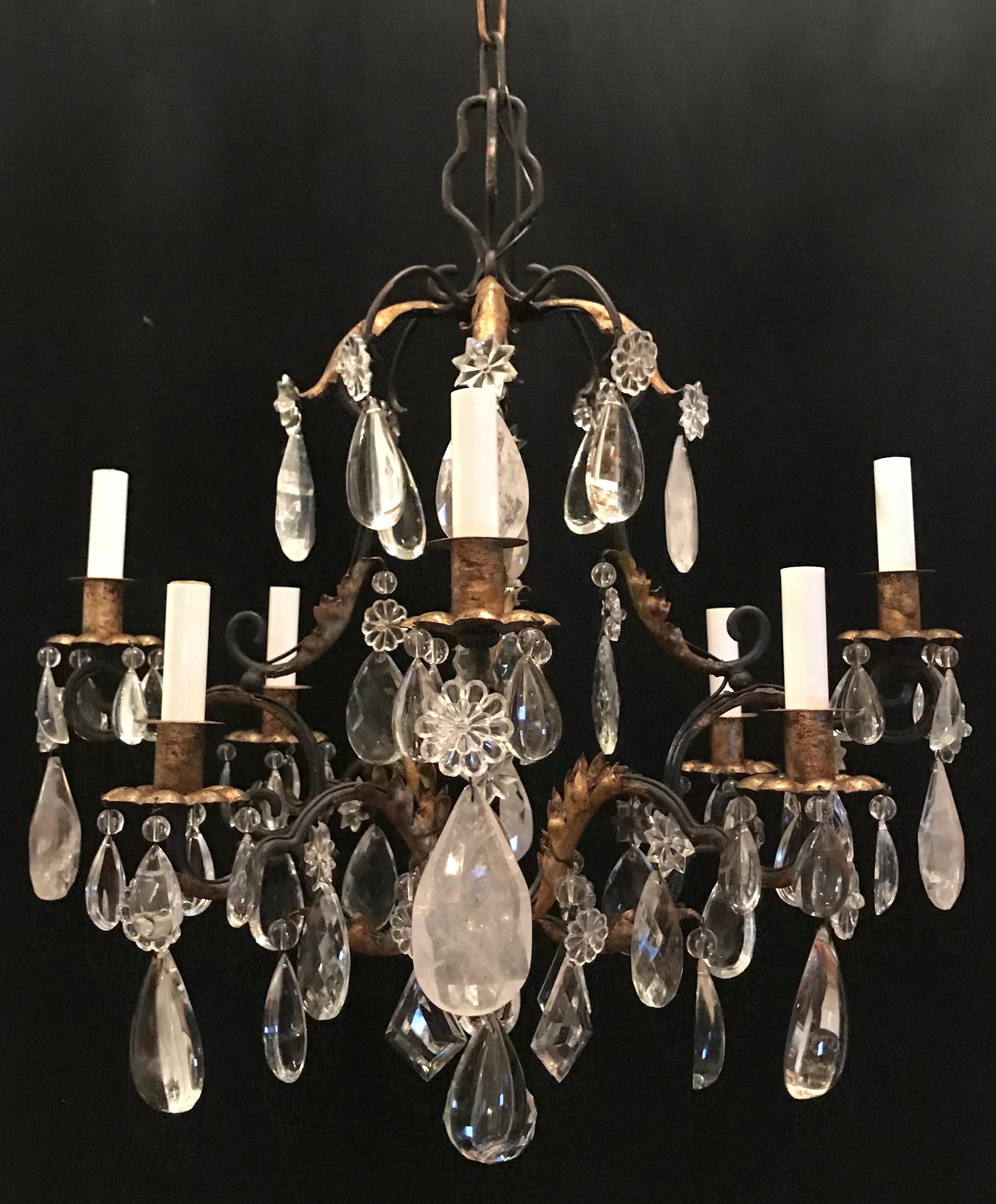 A wonderful Baguès French iron gold gilt rock crystal filigree beaded 8-light chandelier.