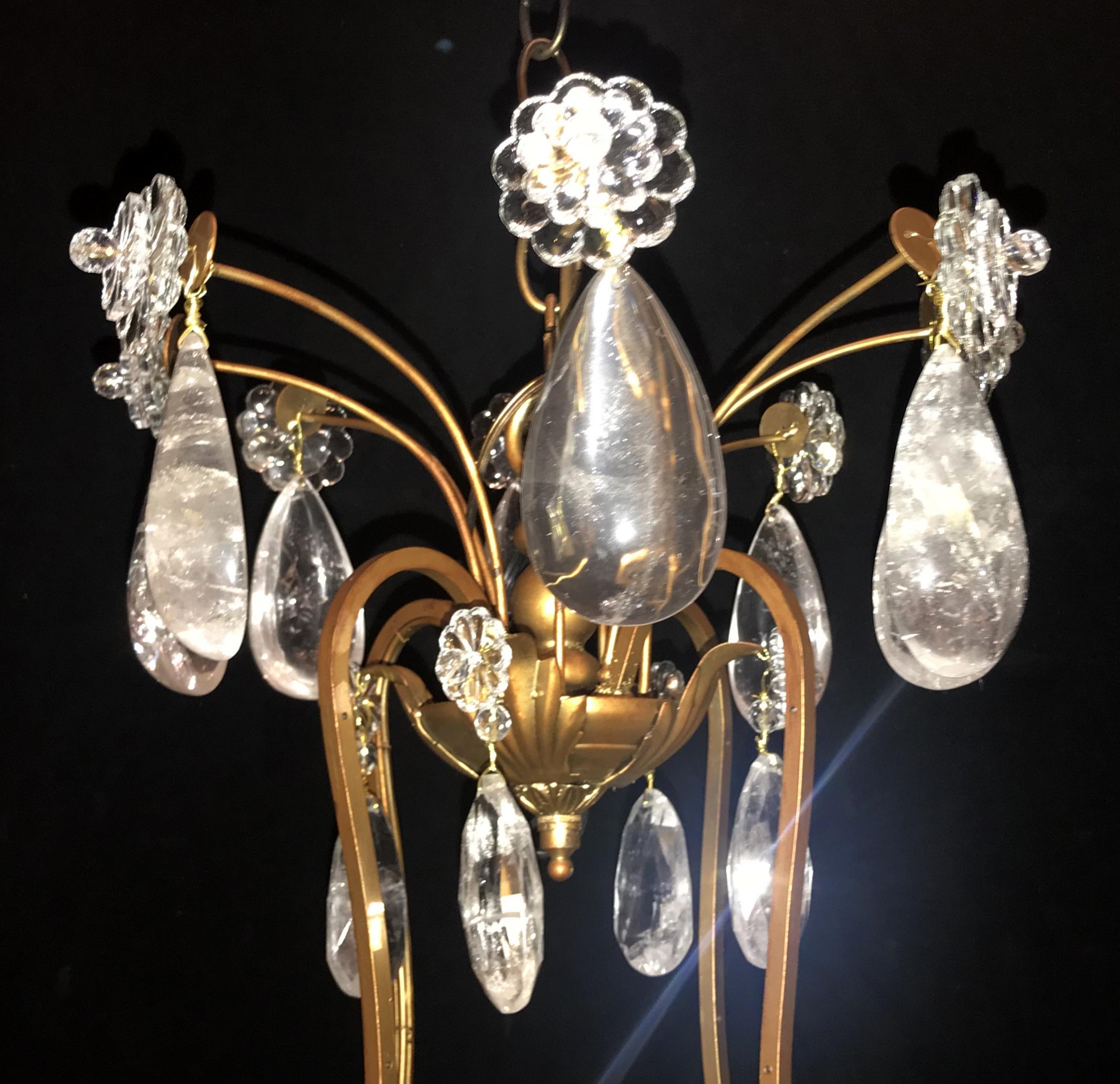 A wonderful Baguès style French rock crystal, gold gilt iron gilt chandelier with eight lights.

Size: H 35 inches x W 32.5 inches.