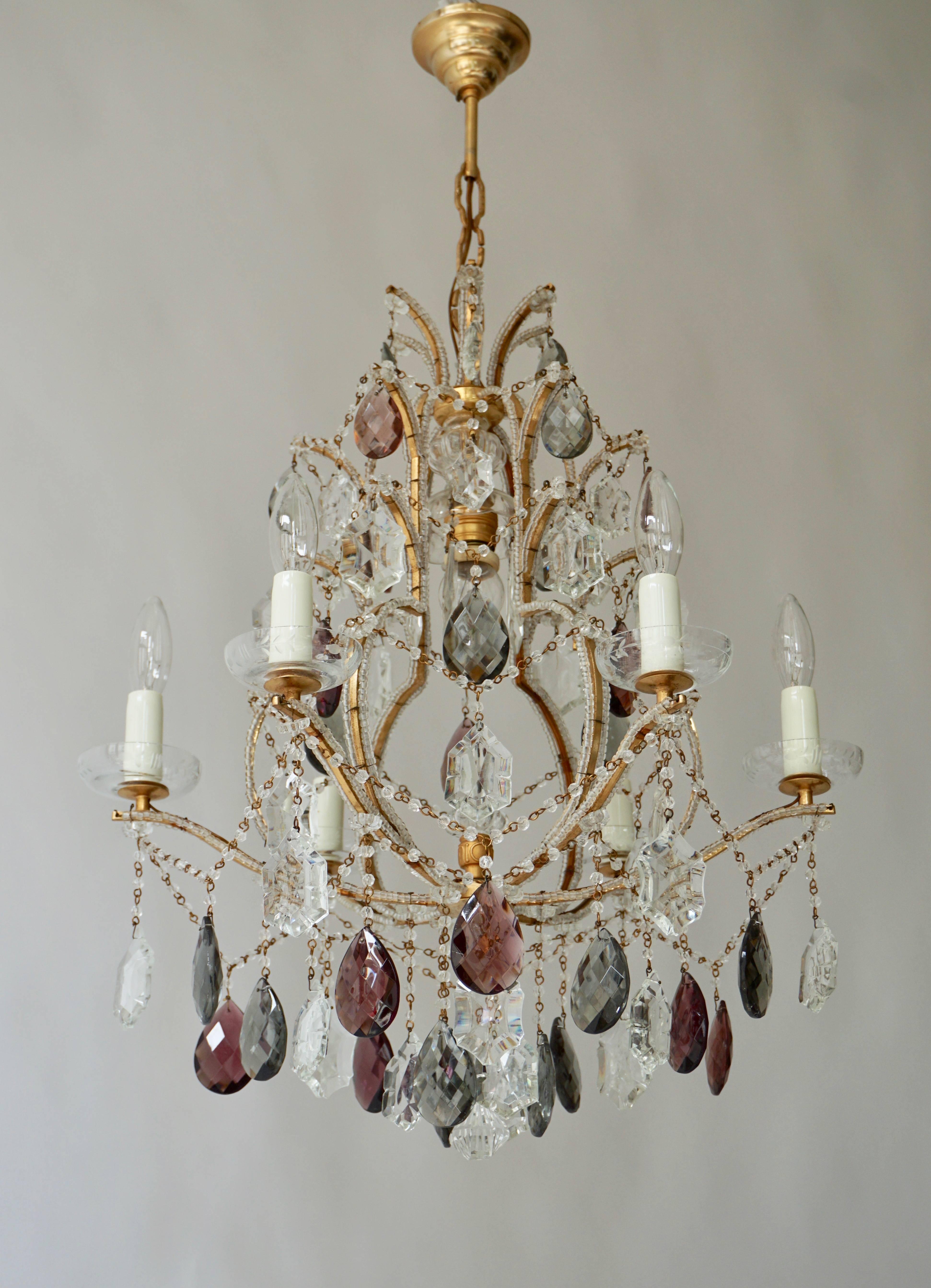 A lovely French iron and rock crystal chandelier with six lights in the manner of Baguès.
Six E14 bulbs and one E27 bulb.
Measures: Diameter 54 cm.
Height fixture 60 cm.
Total height with the chain 85 cm.