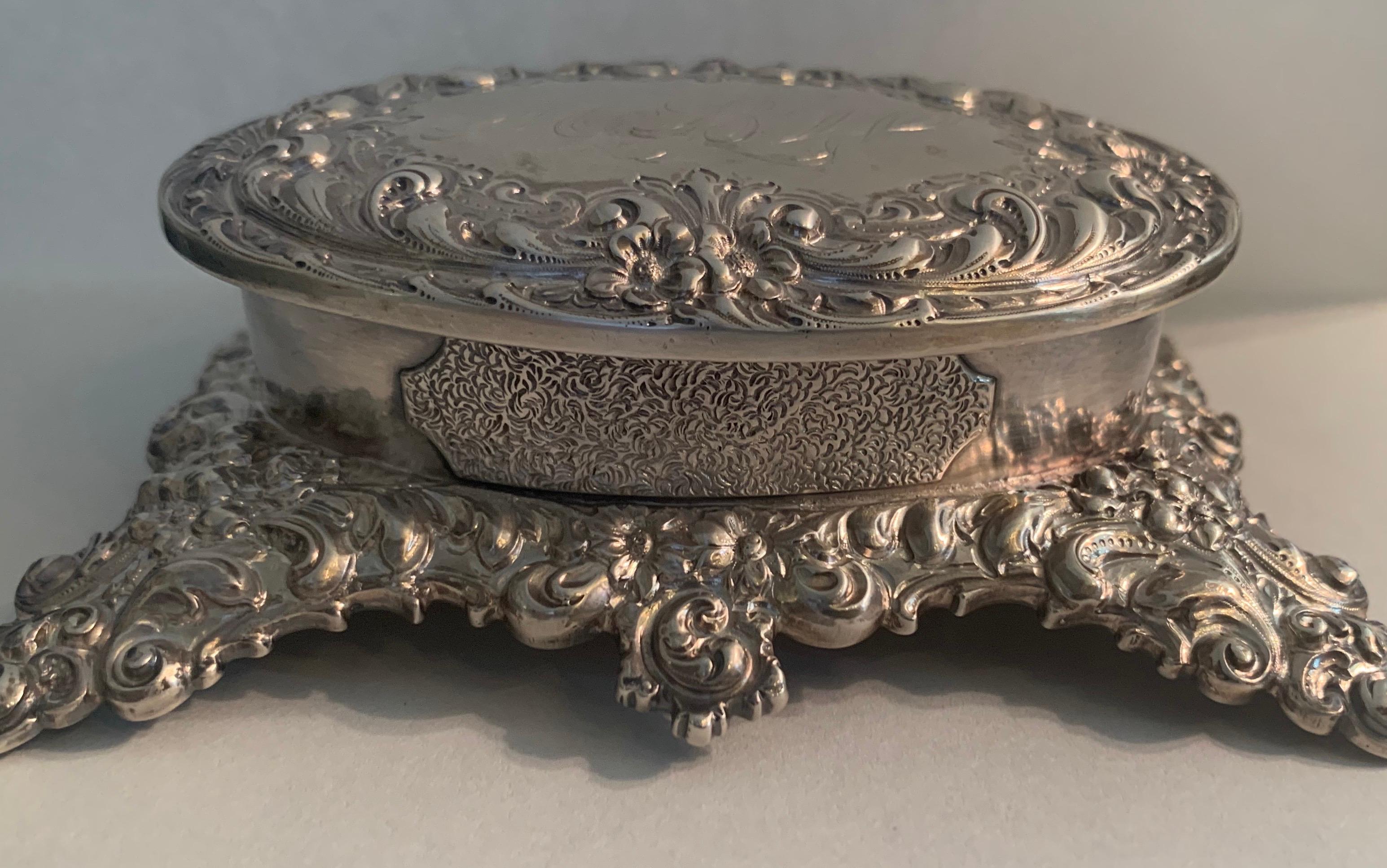 A wonderful Bailey Banks & Biddle Company sterling oval jewelry keepsake footed box.
