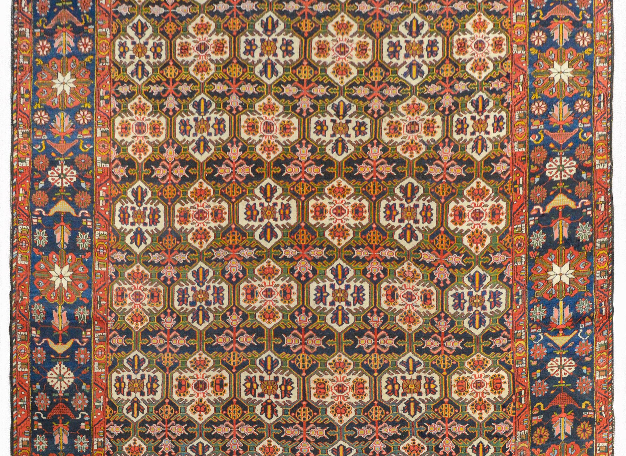 A wonderful 20th century Persian Bakhtiari rug with an all-over trellis and floral pattern woven in rich colors like crimson, gold, green, and indigo, and surrounded by a wide border containing myriad large-scale flowers and leaves, woven in the