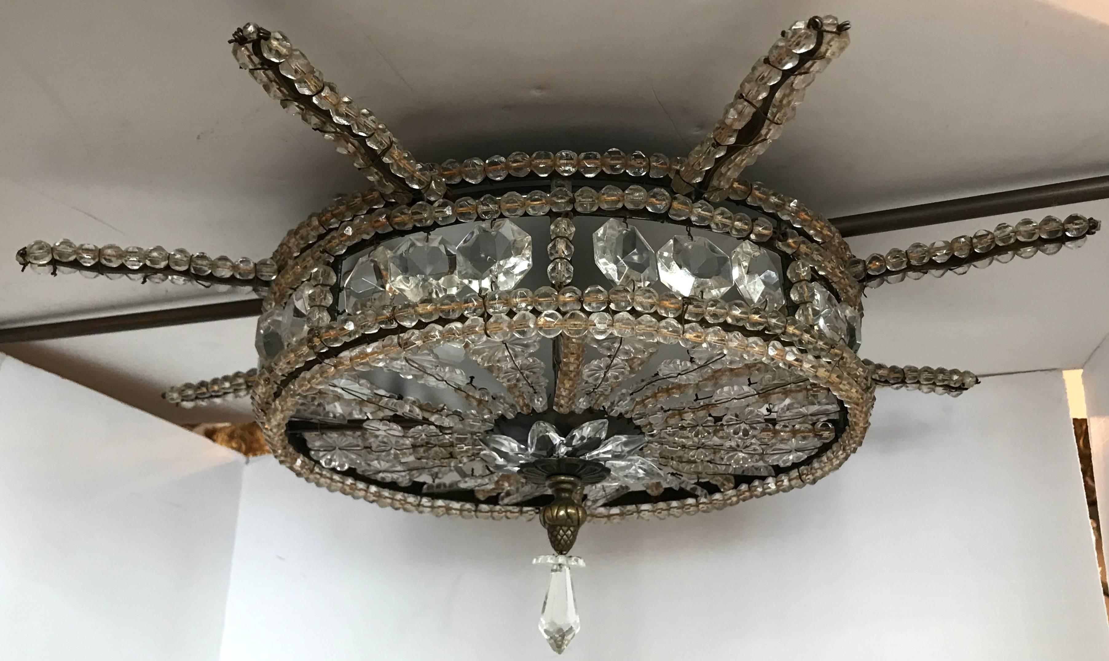 A wonderful beaded crystal flush mount light fixture with three new candelabra sockets and wires in the manner of Bagues / Jansen in the Mid-Century Modern design.