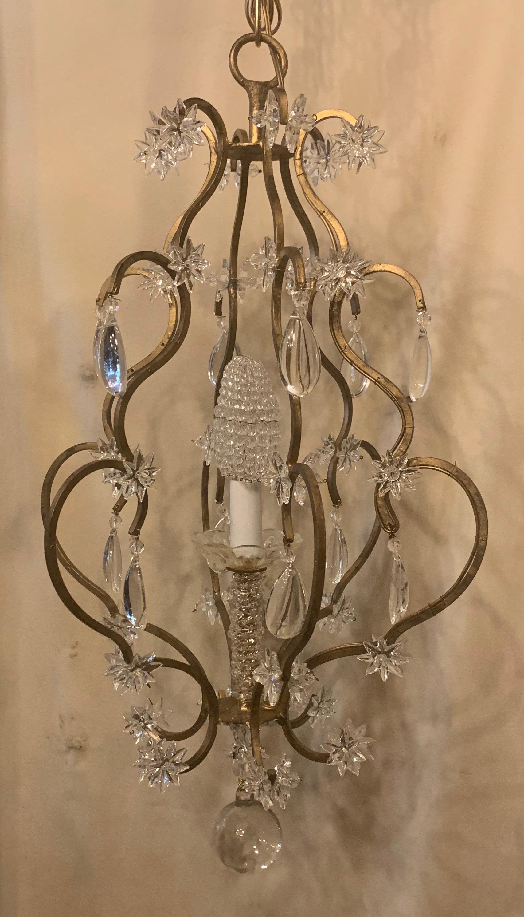 A wonderful beaded gold gilt star basket form pendant chandelier petite single candelabra light fixture with beaded bulb cover, completely rewired and comes with chain, canopy and mounting hardware for installation
In the manner of Baguès.