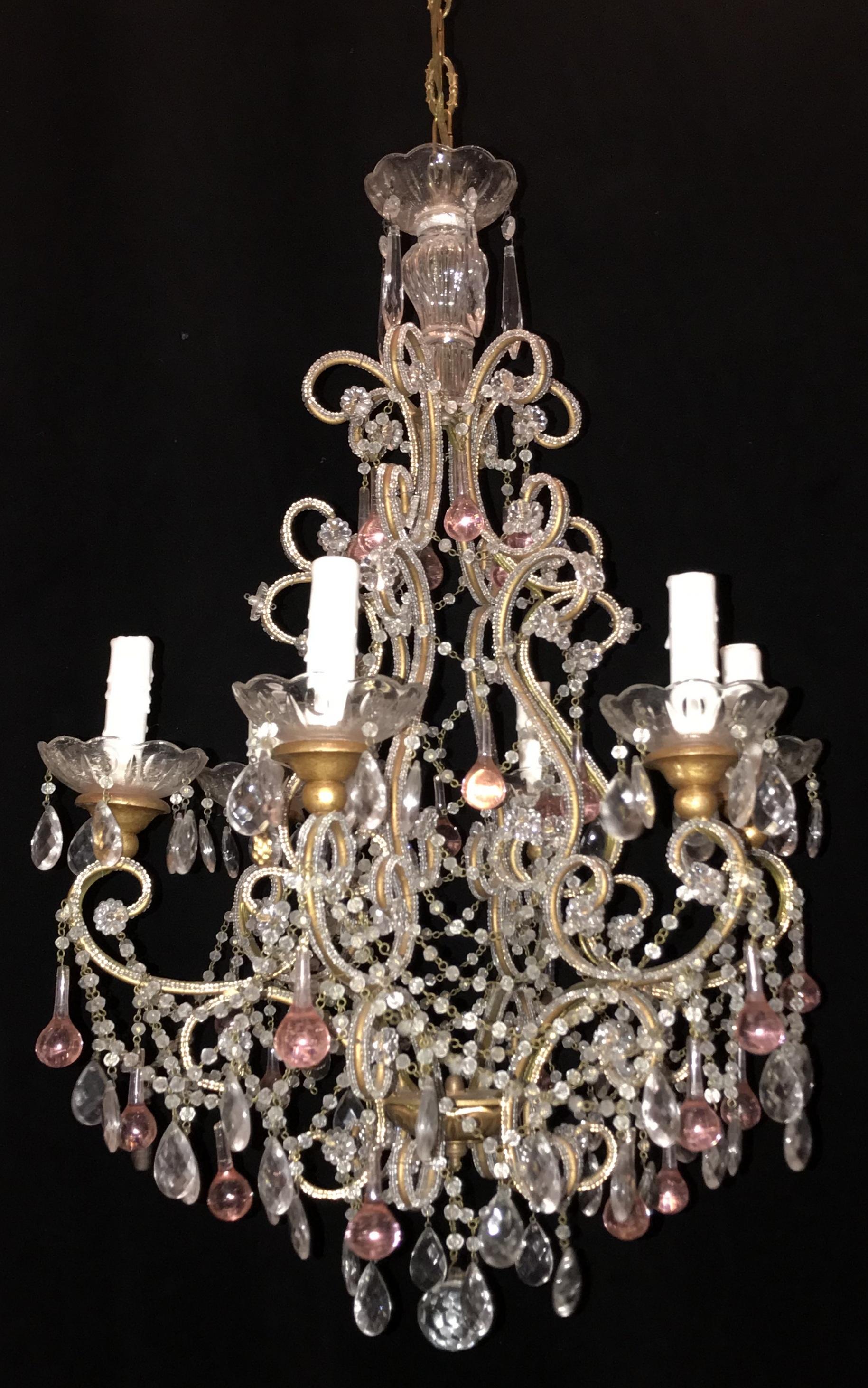 Wonderful beaded Italian giltwood cups and adorned with pink tear drop in a bird cage form chandelier with six candelabra lights, this fixture was purchased from the previous estate of Marc Anthony and Jennifer Lopez.
Measures: 19