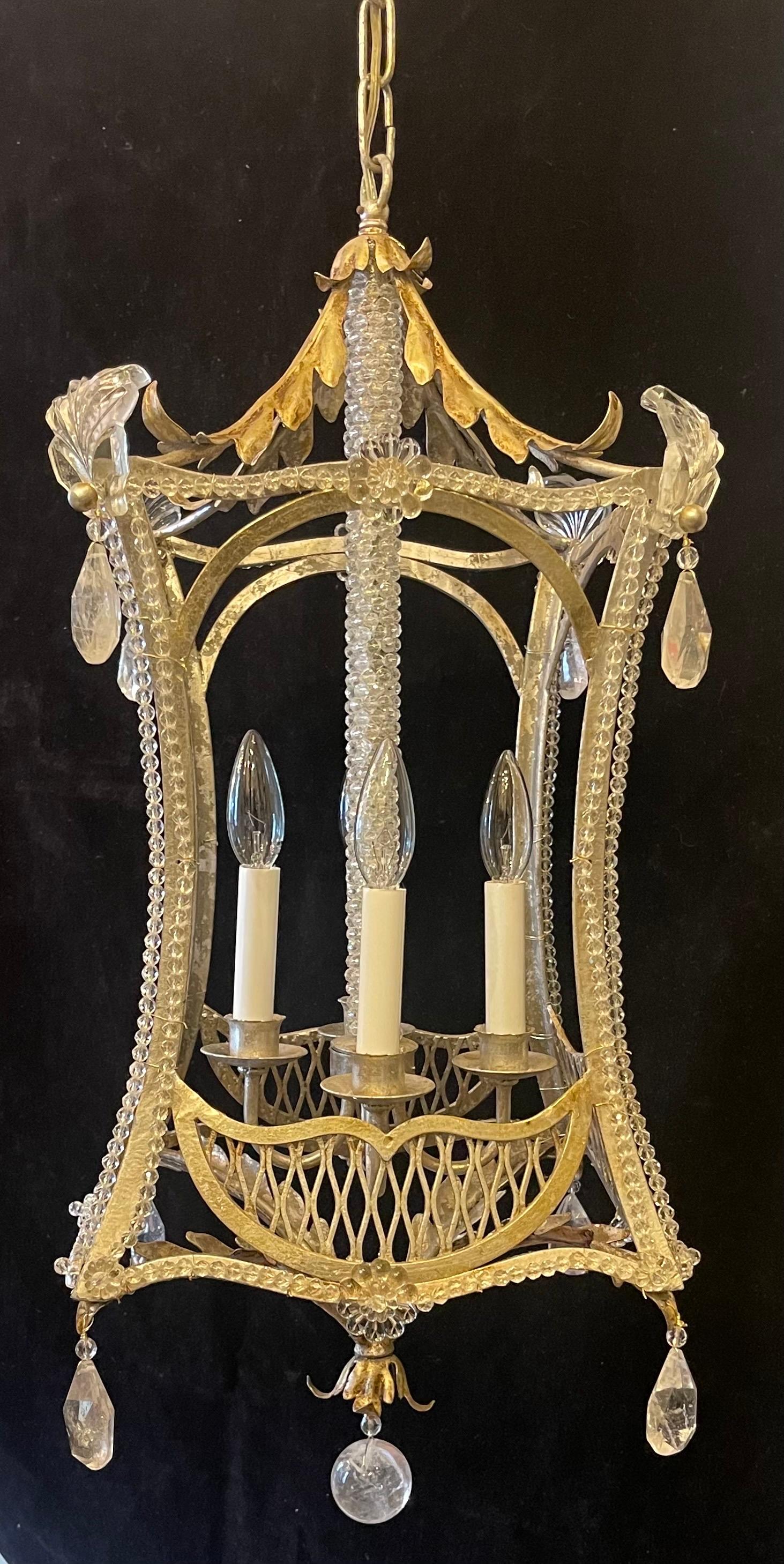 A Wonderful Silver Gilt Pagoda Form Chinoiserie Lantern Chandelier Having A 4 Candelabra Light Cluster Center Wrapped With Crystal Beaded Center Stem. This Beautiful Fixture is Adorned With Rock Crystal Drops And Finished With A Rock Crystal Ball In