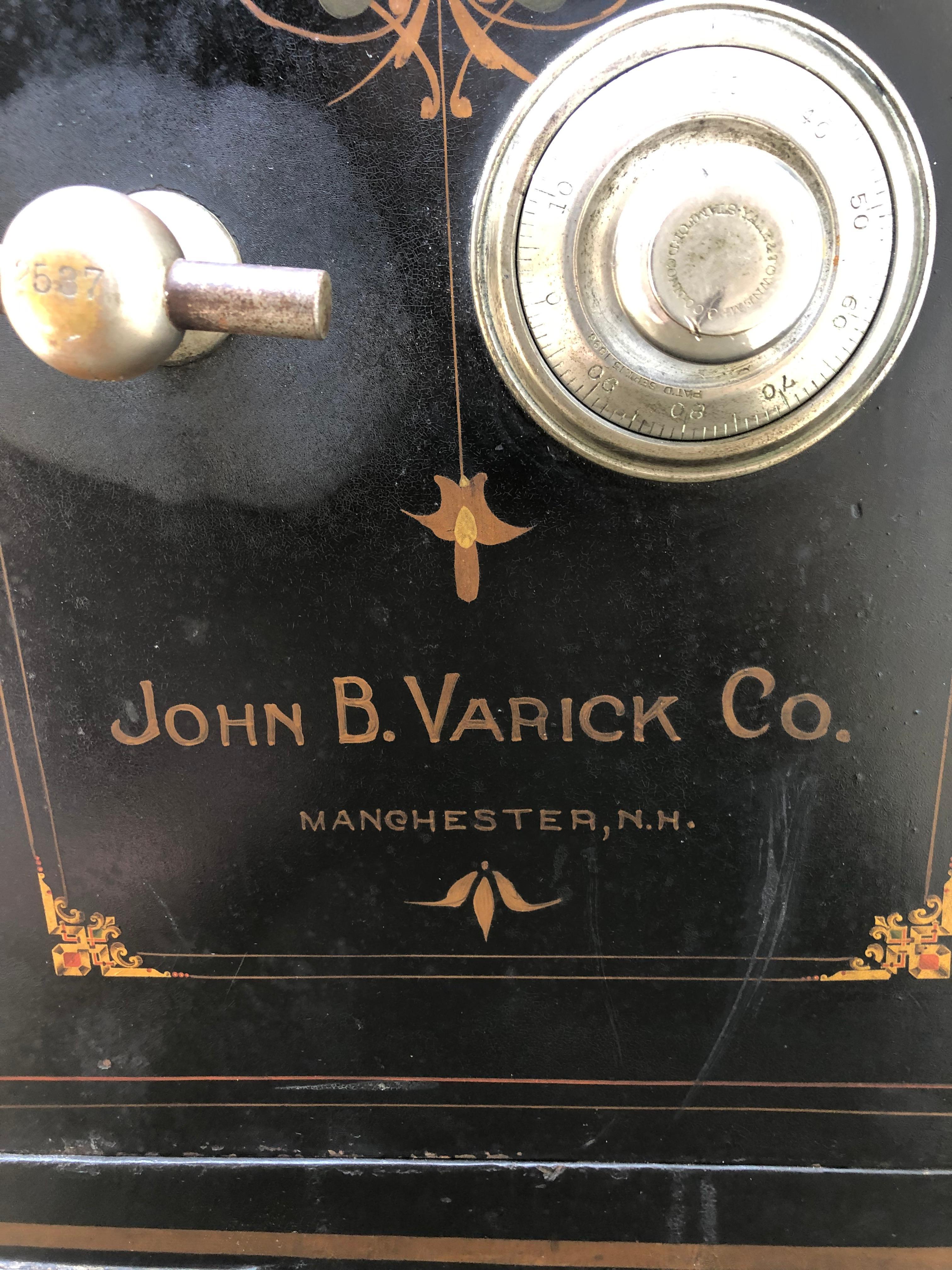 A great looking vintage black cast iron safe having wonderful gold decoration, a lovely landscape painting, silver hardware, chunky iron casters, and the classic name John B Varick Co. The interior has compartments including a small locking section