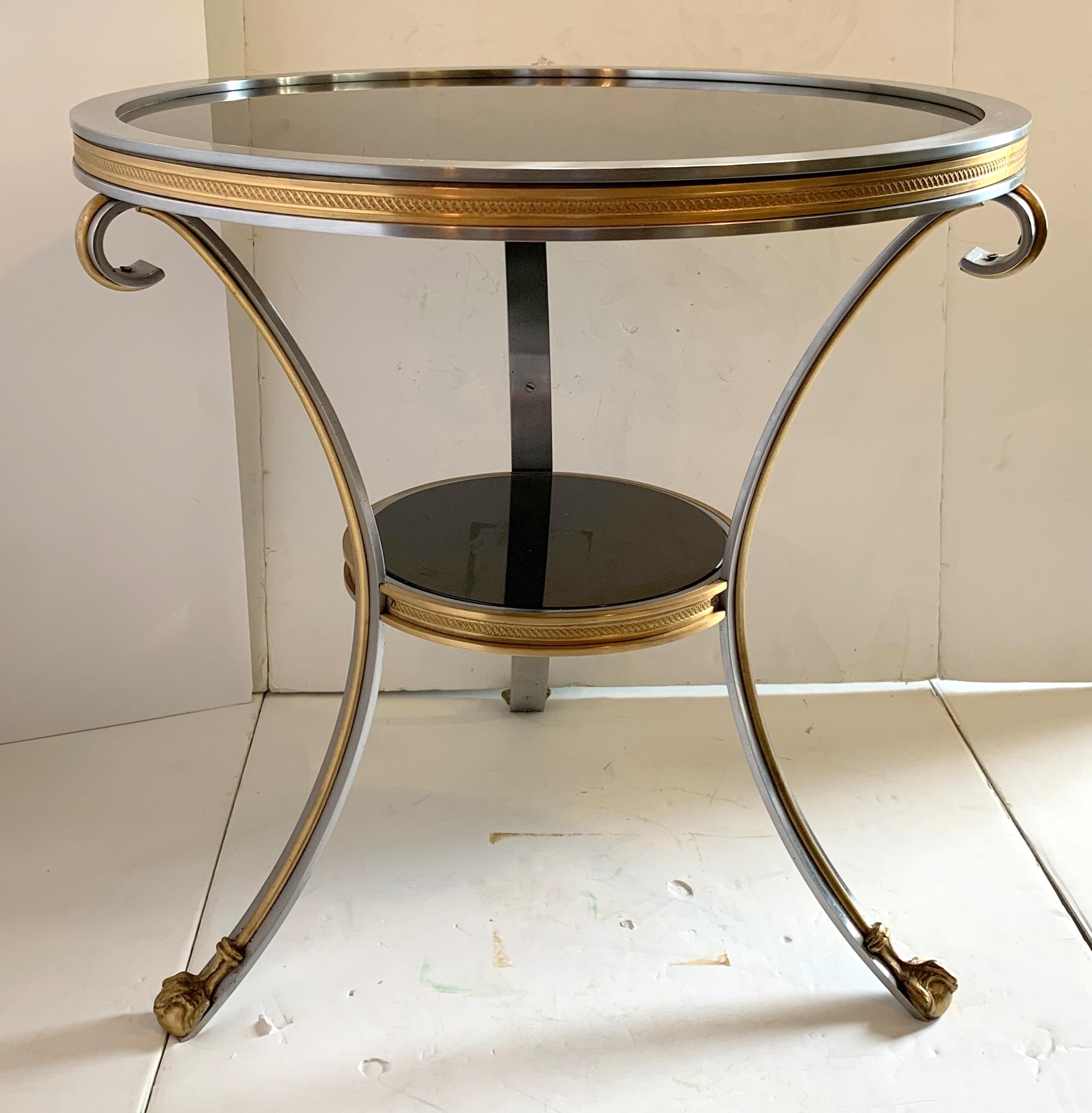 A wonderful black granite two-tier doré bronze ormolu and brushed silver Gueridon / cocktail height end table in the manner of Jansen.