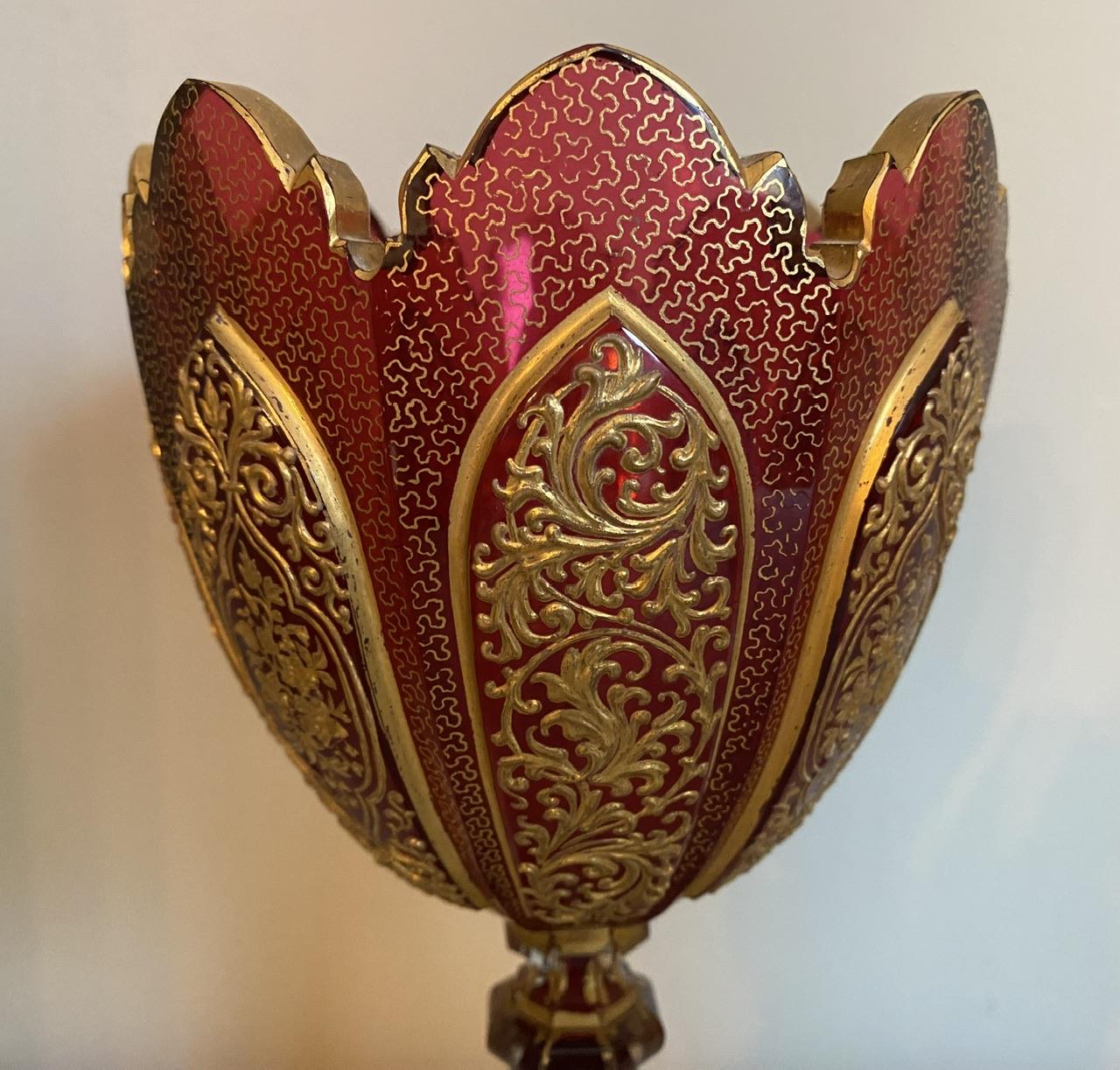 A stunning example of Bohemian Glass, a tall ruby glass vase with gilding and intricate gold filigree work. This is the finest quality of Bohemian glass and in perfect condition.
Height 28 cm
Diameter 13 cm