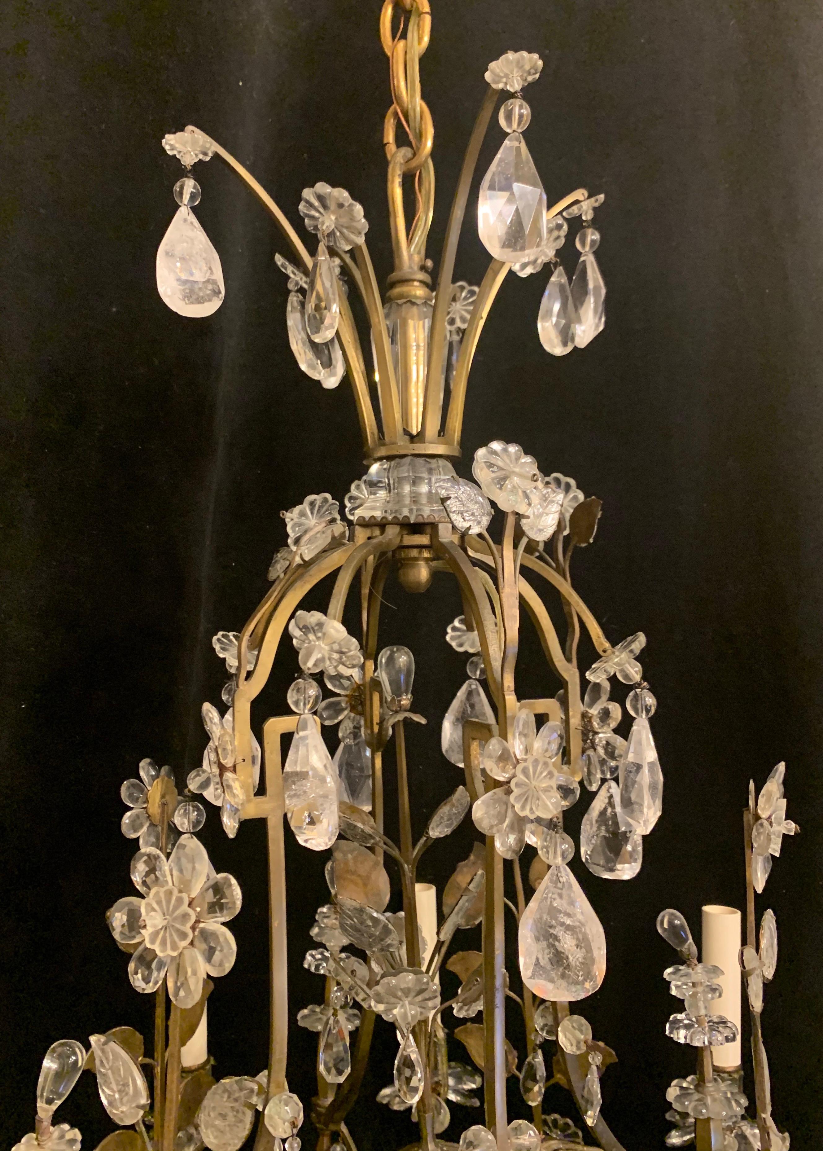 A wonderful bronze and rock crystal beaded basket center, and free standing flower Maison Baguès chandelier, rewired and accompanied by chain canopy and mounting hardware for installation.