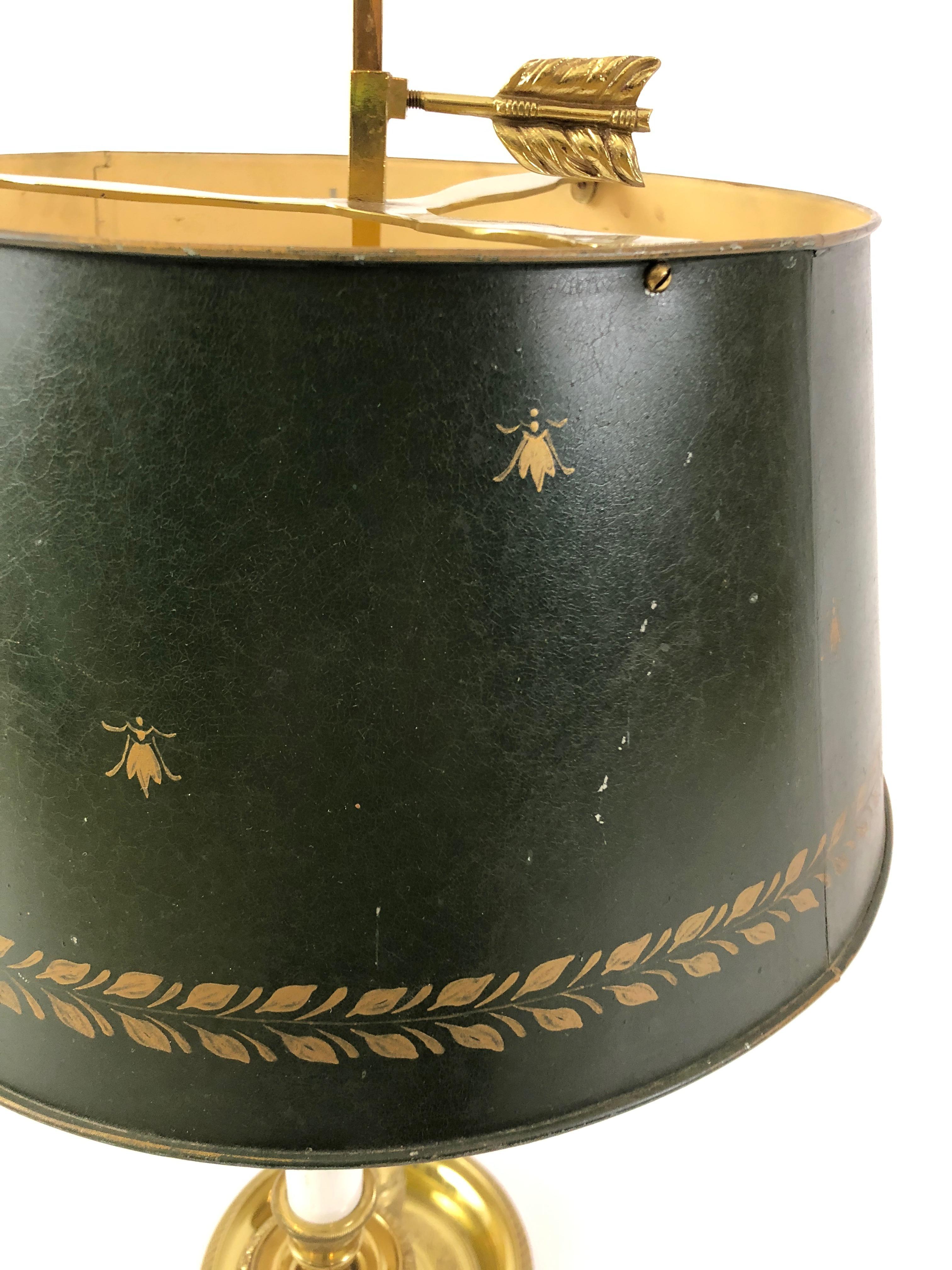Classic French brass bouillotte lamp having 3 curvy candlestick arms, arrow finial, etched brass base and wonderful tin shade with decorative gold bees adorning it.
