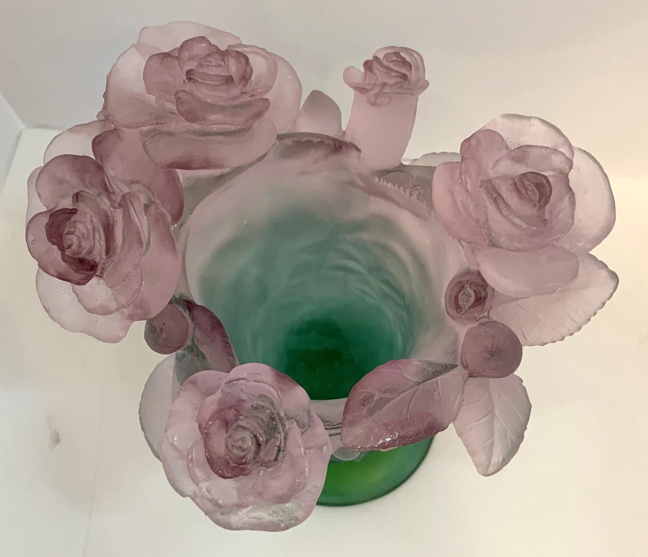 A wonderful contemporary Pate De Verre vase created by Daum France, having lilac baby roses encircling the top rim, in various stages of growth, the foliage stems follow the graceful contour of the green body. Approx. 7