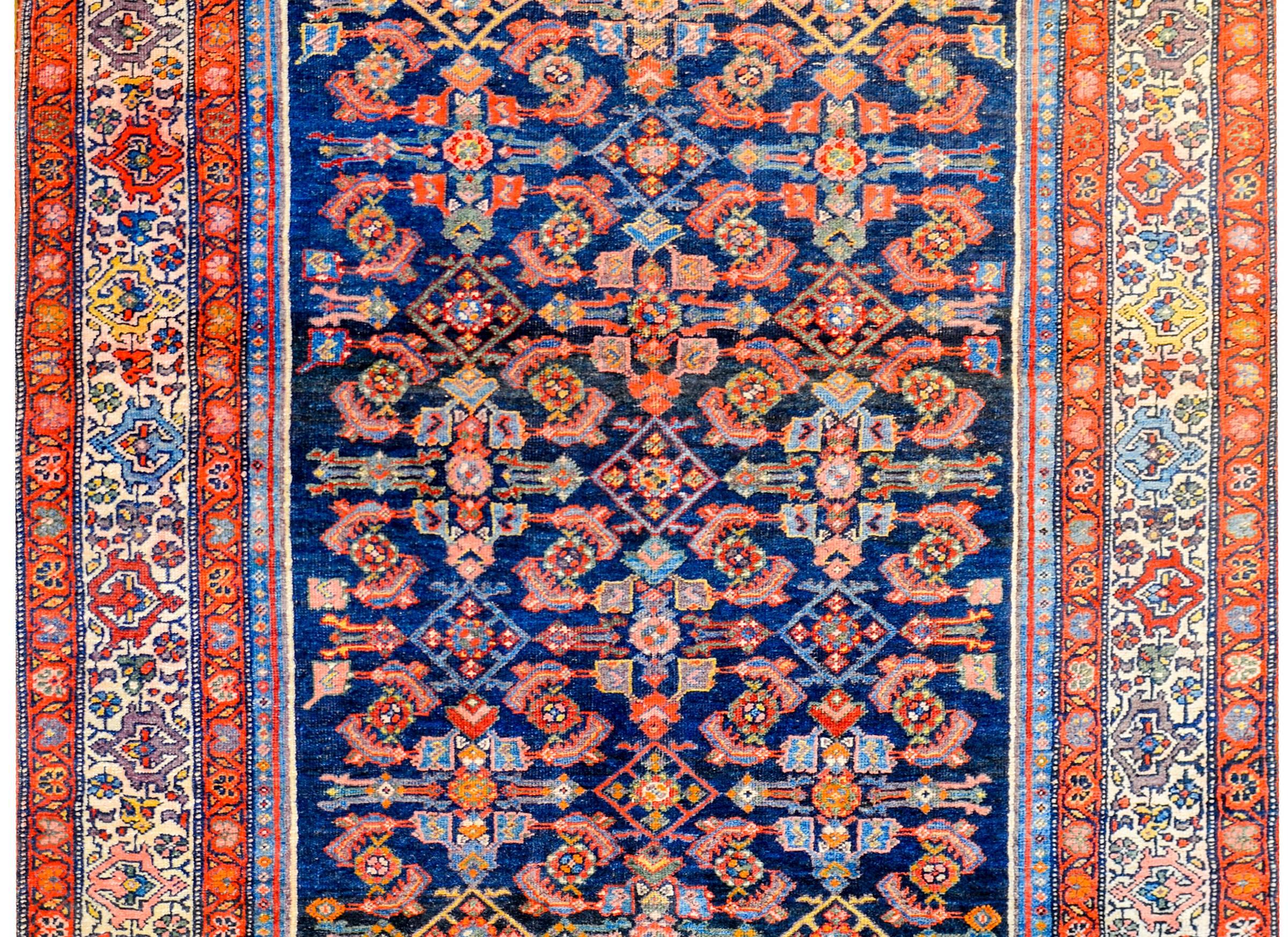 Exceptionnel tapis persan Bidjar du début du 20e siècle, avec un fantastique champ central composé d'un motif floral et de treillis de vigne, rendu en laine végétale brillante de couleur cramoisie, or, indigo clair et crème, sur un fond indigo