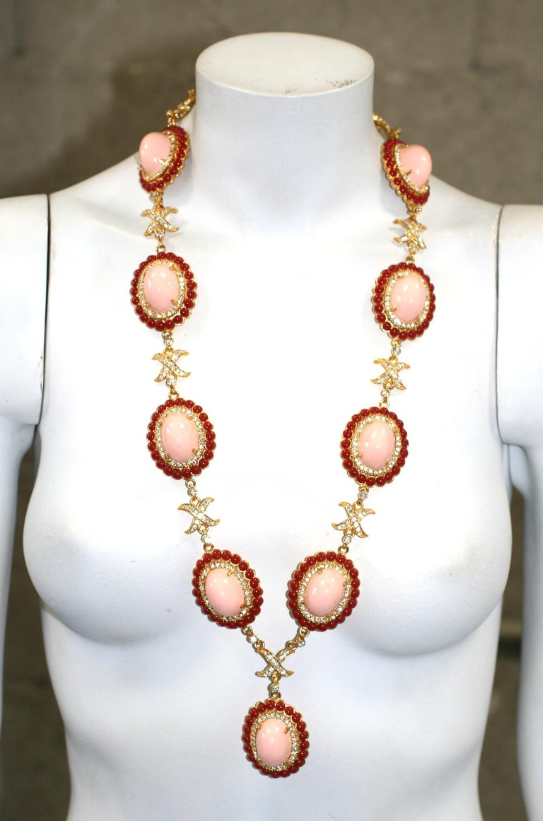 Wonderful, early Kenneth Jay Lane Faux Coral Necklace from the 1960's. Made in a bold 1960's Bulgari style in tones of faux pink and red coral set in gilt metal. Huge high cab, faux pink coral cabochons are surrounded by faux red coral stones with