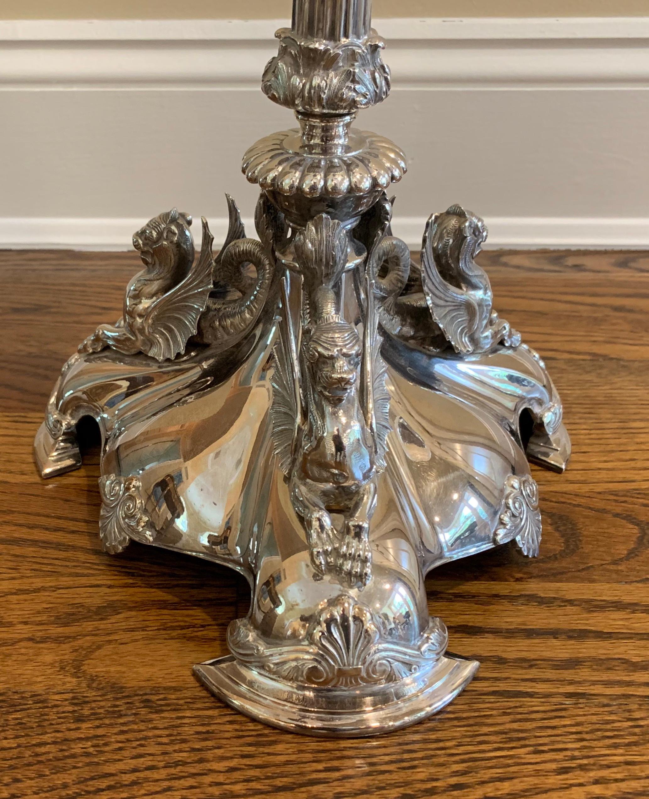 A wonderful Elkington English silver plate lion epergne with 1 large center and 3 smaller side etched glass bowls centerpiece.