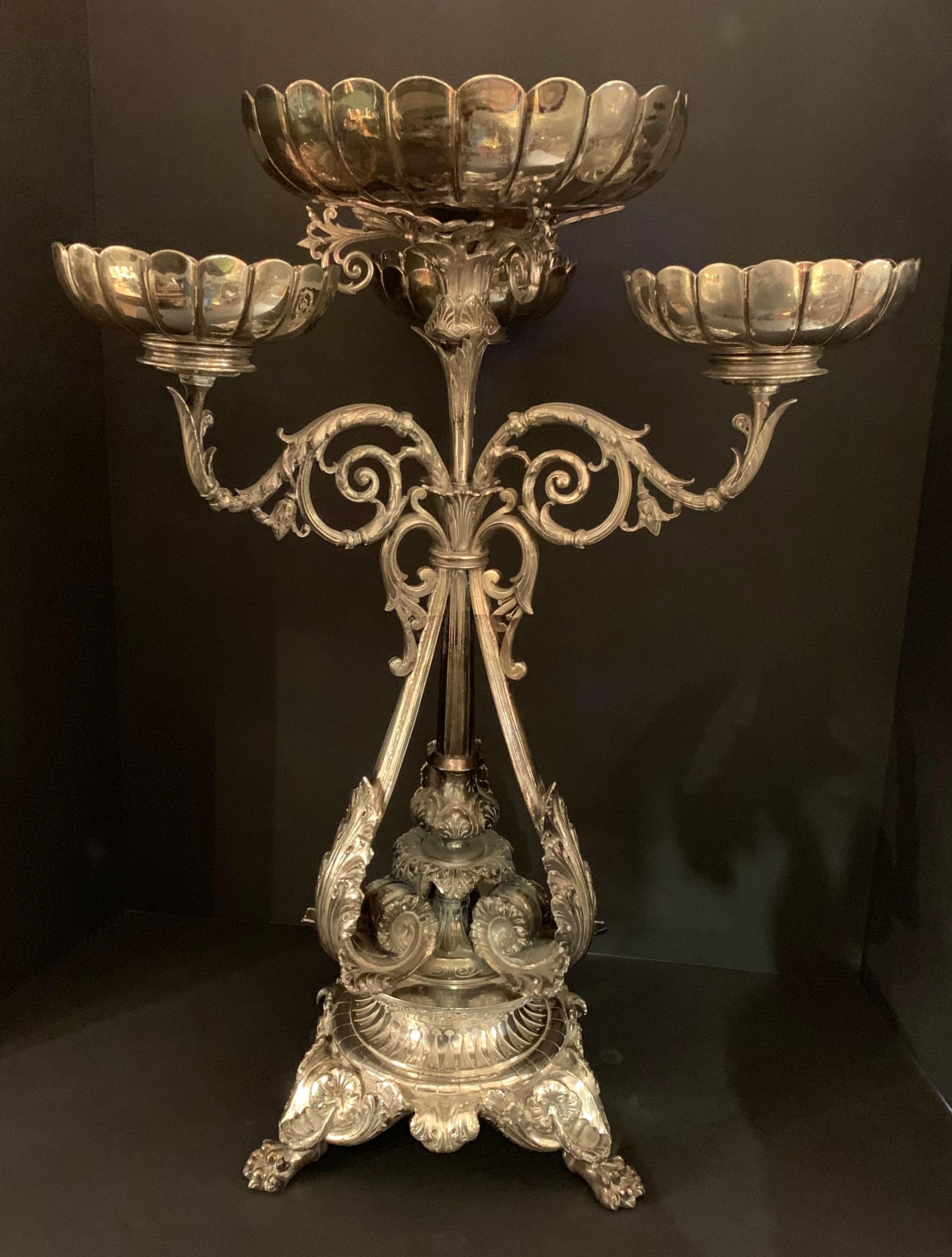 A wonderful English Regency silver plated Epergne by J. Lyons & Co., Elkington Co. with three scalloped bowl surrounding a larger center bowl with very fine heavy chasing.