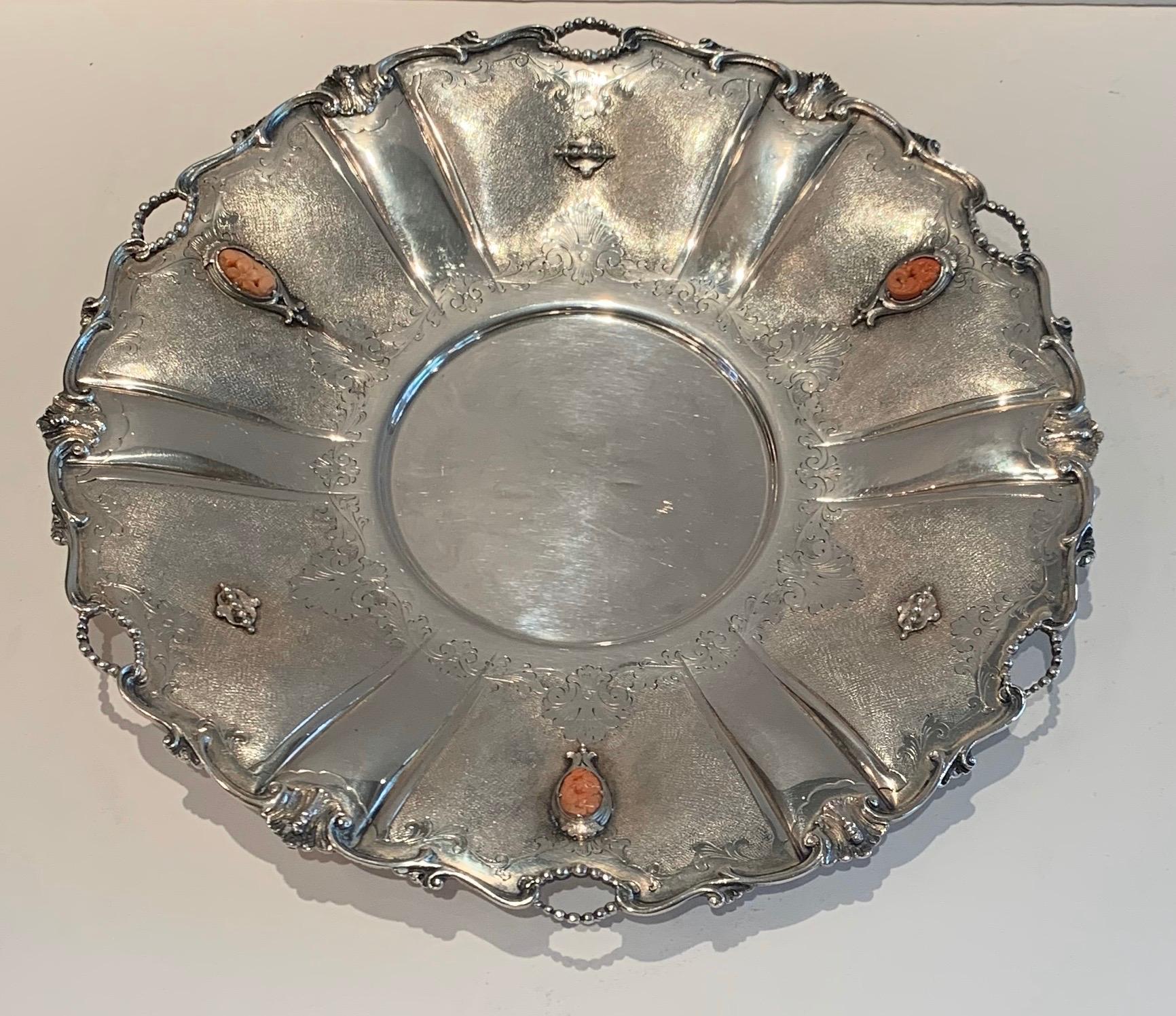 A wonderful European 800 sterling silver round platter with pierced border and mounted with 3 carved coral decorations.