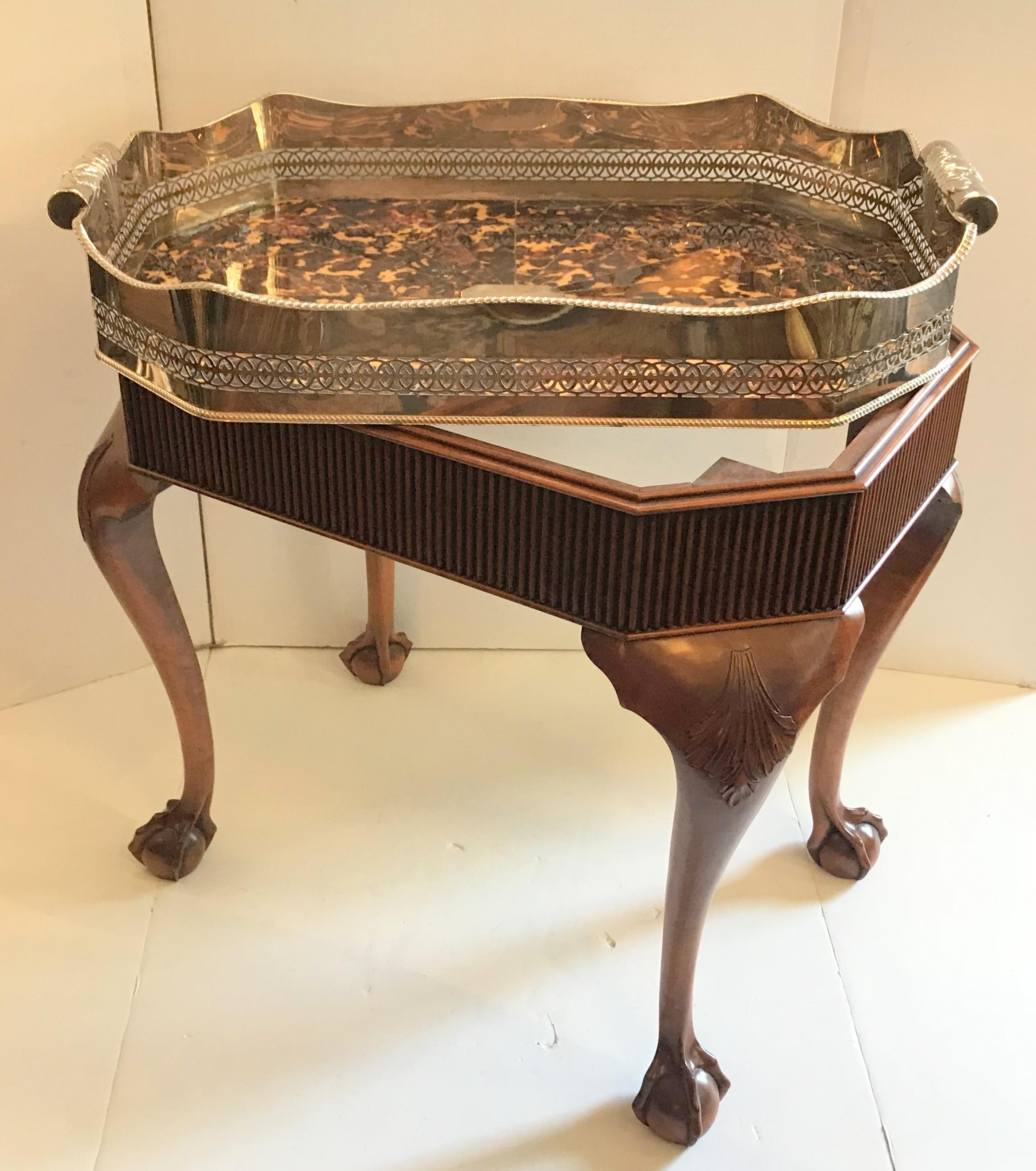 A wonderful faux tortoiseshell and silver plated English gallery tray, which can be removable from the mahogany table base that accompanies it. This beautiful serving piece has a prominent pierced and scalloped gallery and tooled with intricate fret