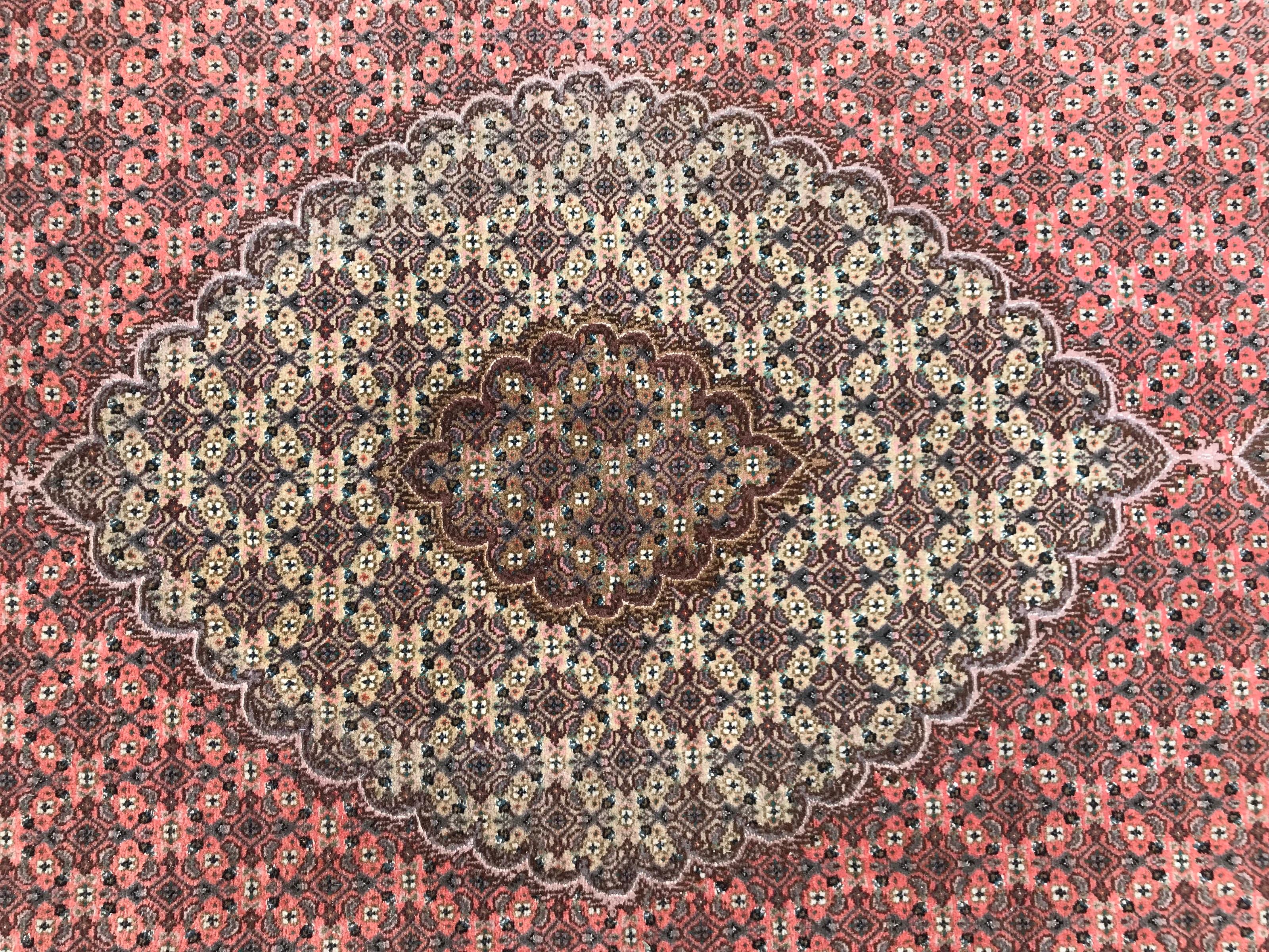 Nice late 20th century rug with beautiful fine design with stylized flowers and a nice central medallion, and beautiful colors with orange, green, brown and grey, entirely hand very finely hand knotted with wool velvet on cotton foundation.