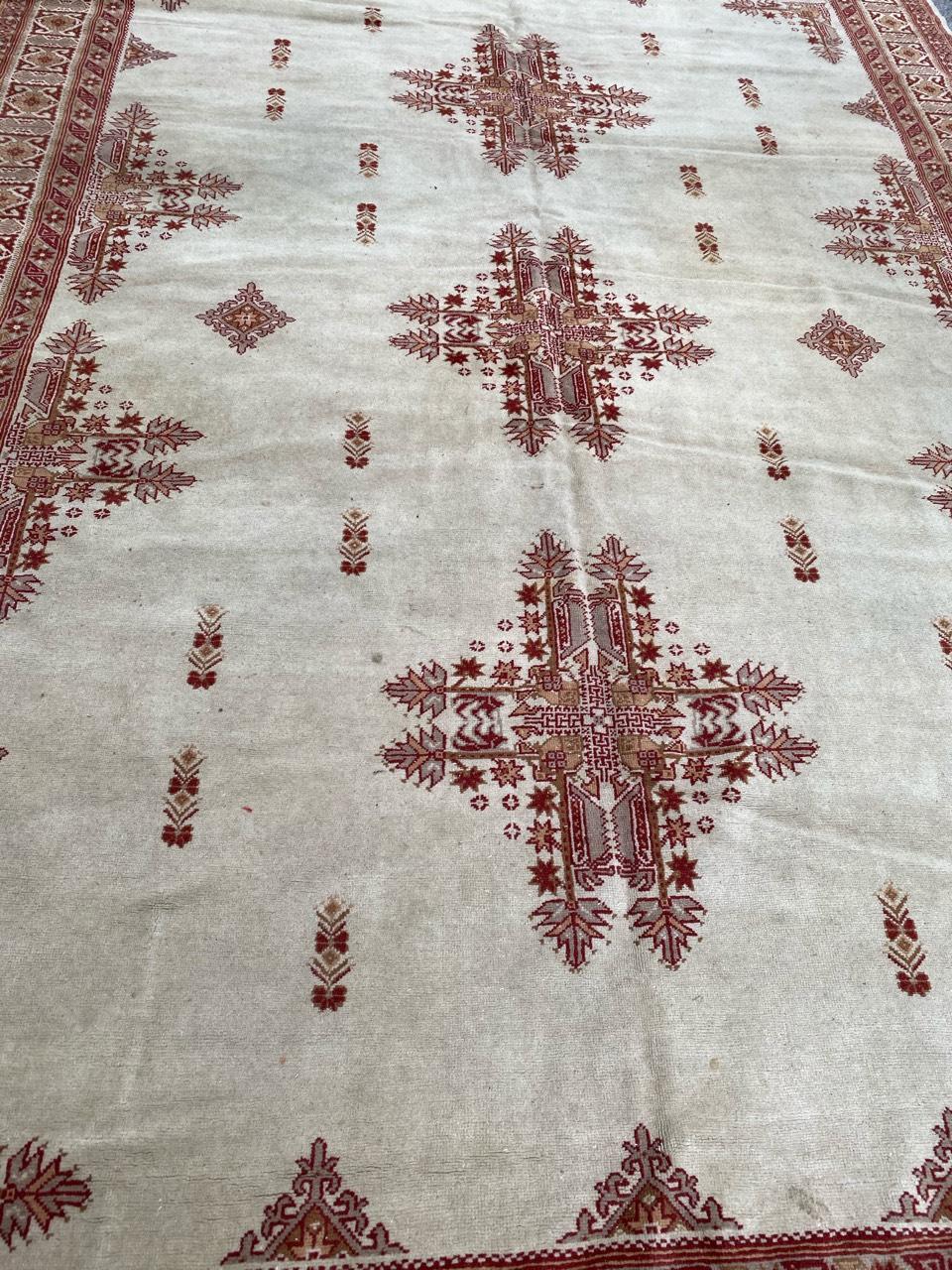 Very beautiful vintage Tunisian rug with a nice tribal design and white, purple, yellow and grey colors, entirely and finely hand knotted with wool velvet on cotton foundation.