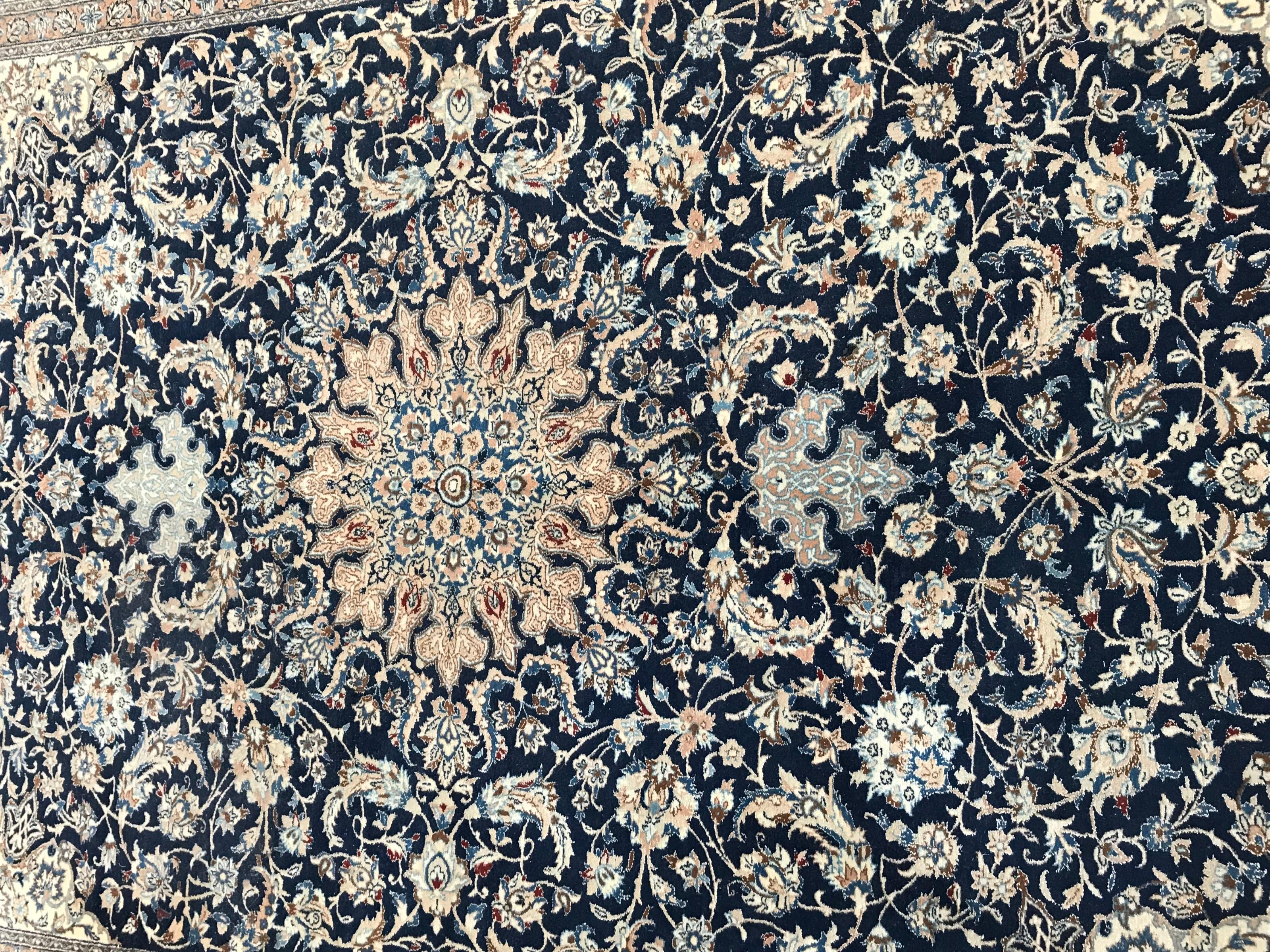 Very beautiful and fine rug with a nice floral design with central medallion and a blue field color, entirely and finely hand knotted with wool and silk velvet on cotton foundations.